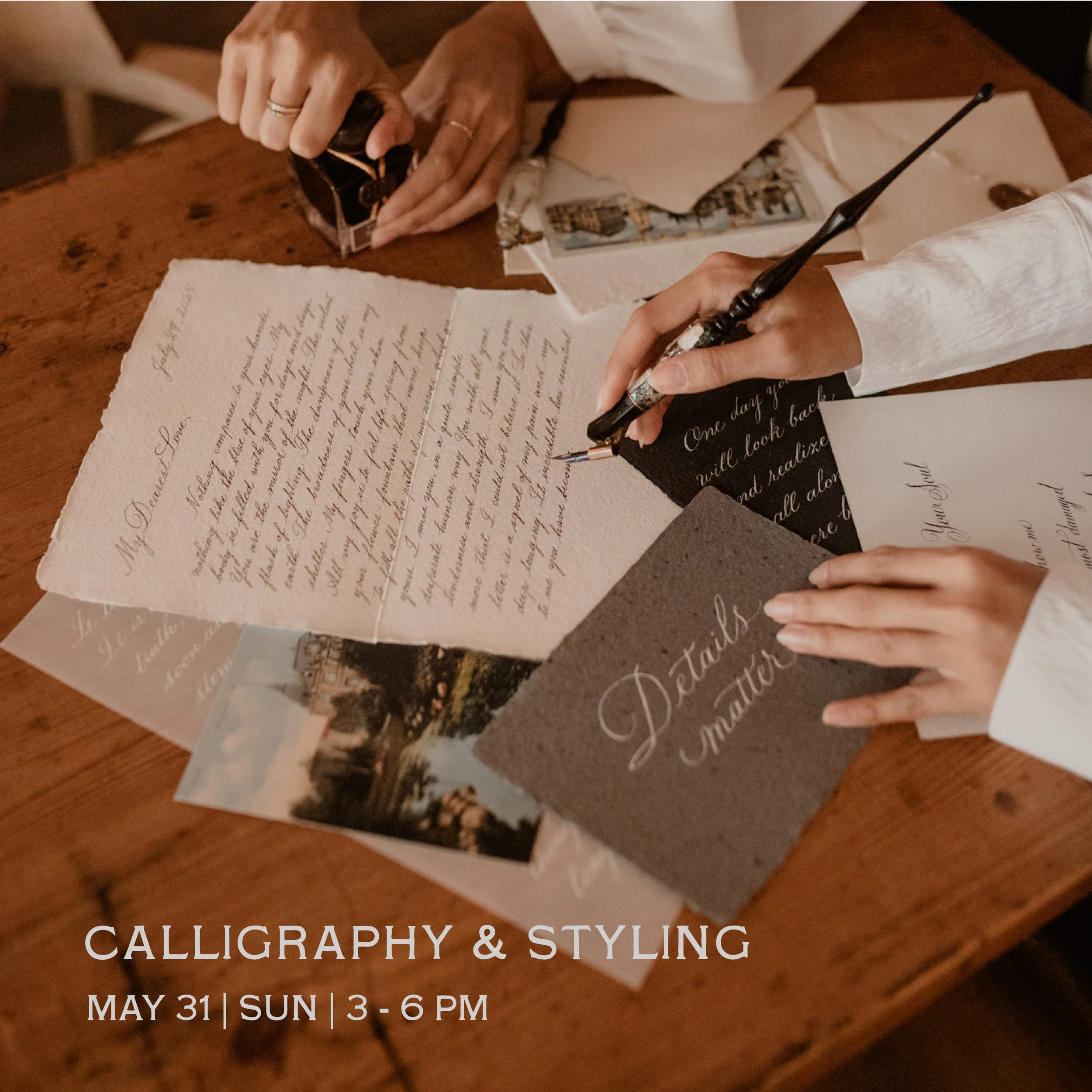 Hands writing calligraphy with various papers and photographs on a wooden table.