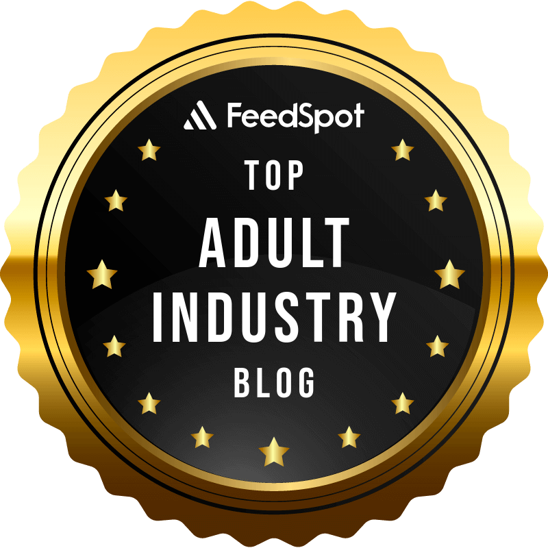 Award badge with gold border and black center, labeled "FeedSpot Top Adult Industry Blog" with gold stars surrounding the text.