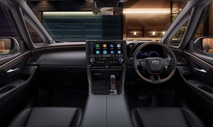Interior view of a modern Toyota vehicle dashboard with a touchscreen display, steering wheel, and center console.
