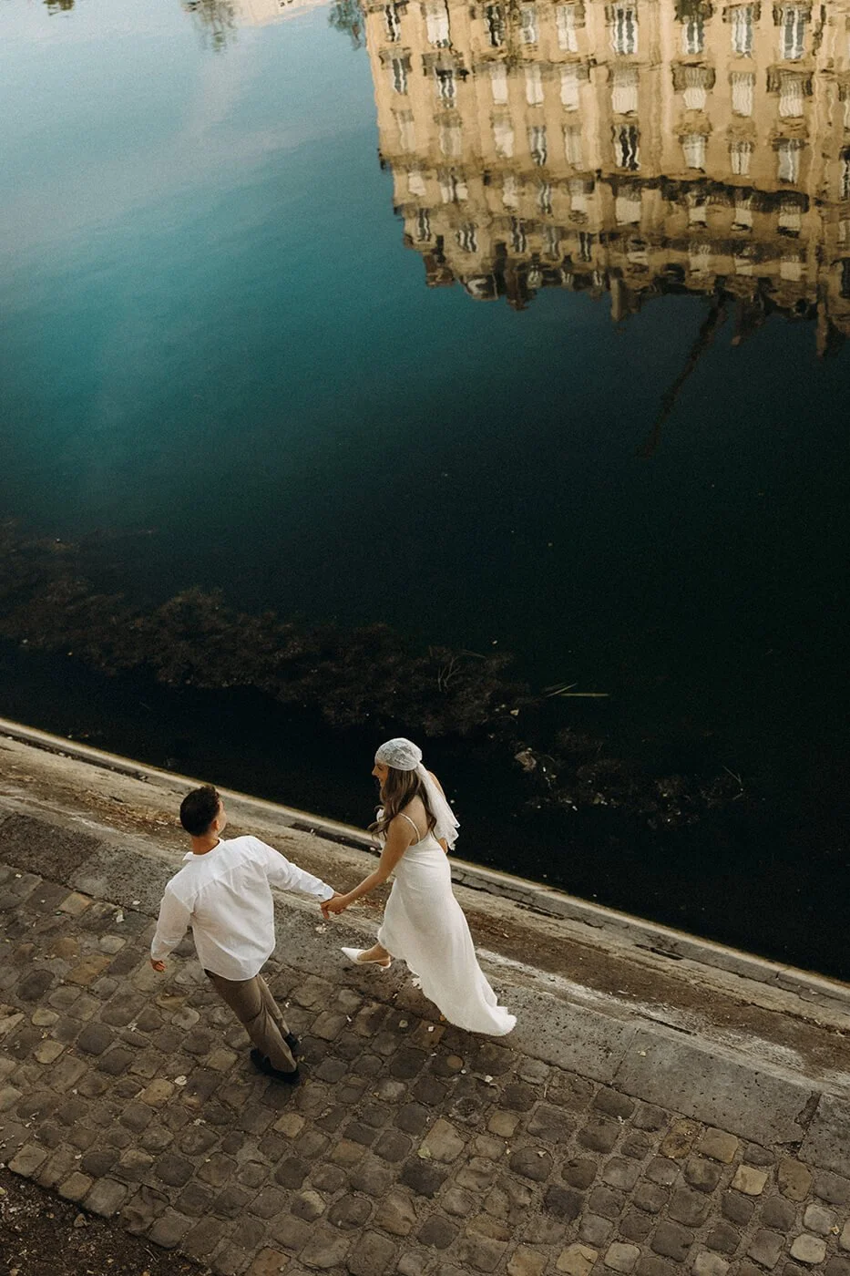 Intimate Paris elopement moment by the river, natural and emotional couple photography in a historic Paris setting.