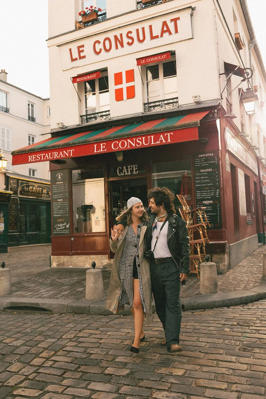 Engagement session at Le Consulat café in Montmartre, romantic Paris couple photos captured by a destination engagement photographer.