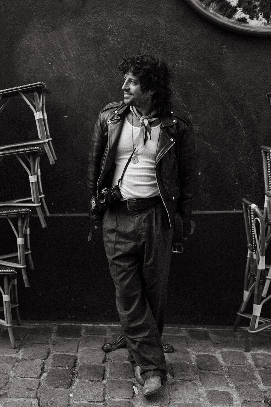 Close romantic portrait of a couple at a Paris café during their engagement session, soft light and authentic connection.