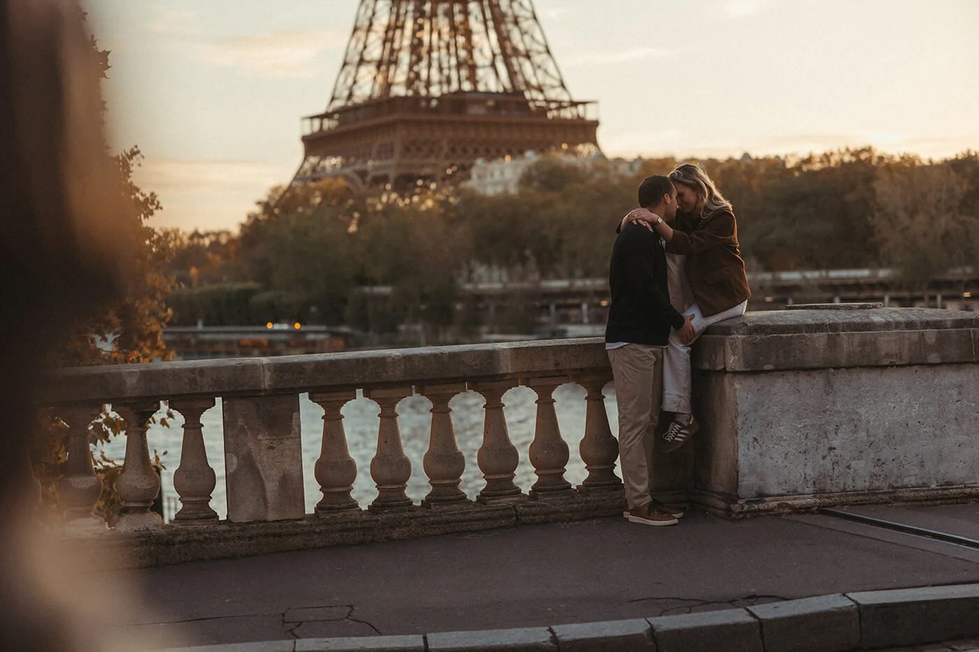 Warm candid portrait of a couple during a golden hour Paris photoshoot.