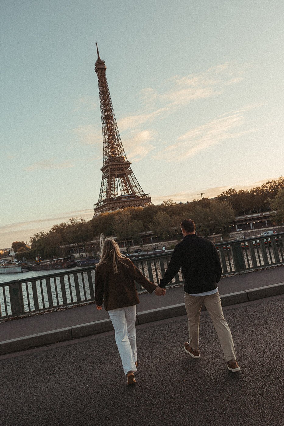 Couple walking hand in hand during a romantic Paris city session.