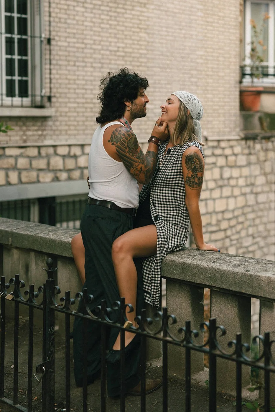 Candid moment during engagement photoshoot couple on the balcony.