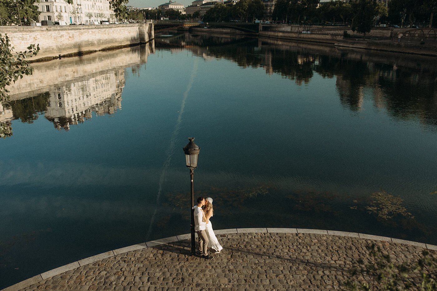 Intimate Paris elopement moment by the river, natural and emotional couple photography in a historic Paris setting.