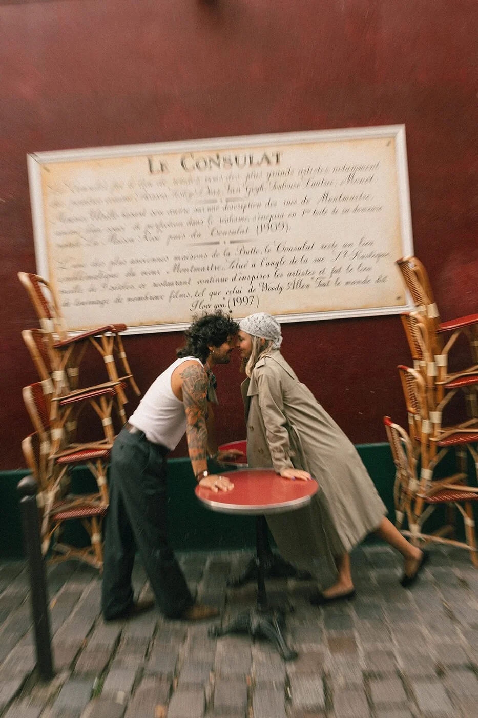 Engagement session at Le Consulat café in Montmartre, romantic Paris couple photos captured by a destination engagement photographer.