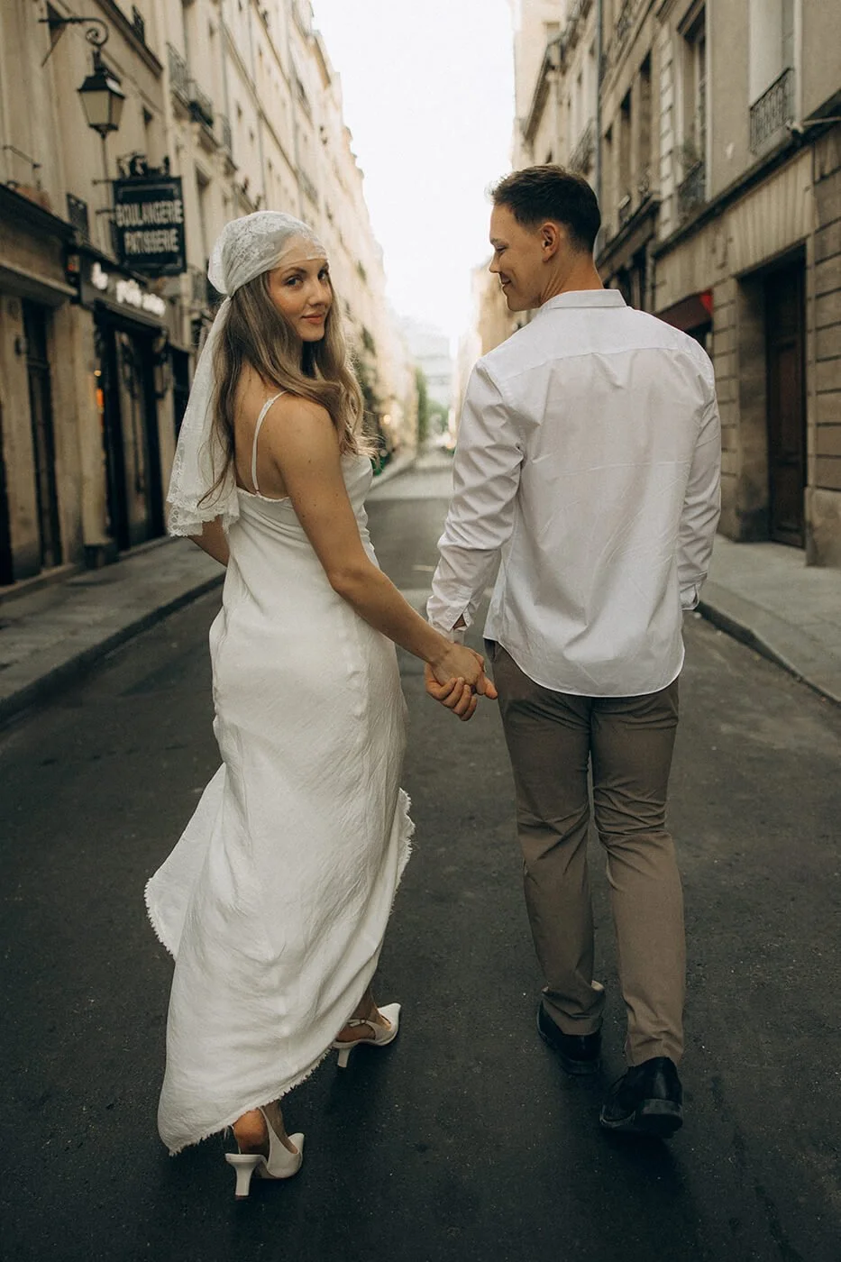 Candid couple walking on the streets, lifestyle engagement photography in the heart of Paris.