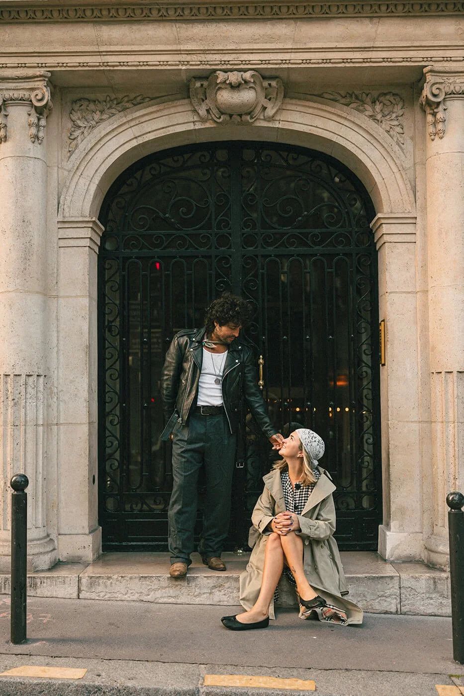 Romantic engagement session in Paris on historic stone steps, candid couple moment in Montmartre neighborhood.