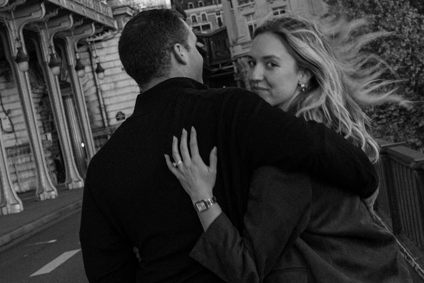 Couple walking together during a cinematic Paris photoshoot near the Eiffel Tower.