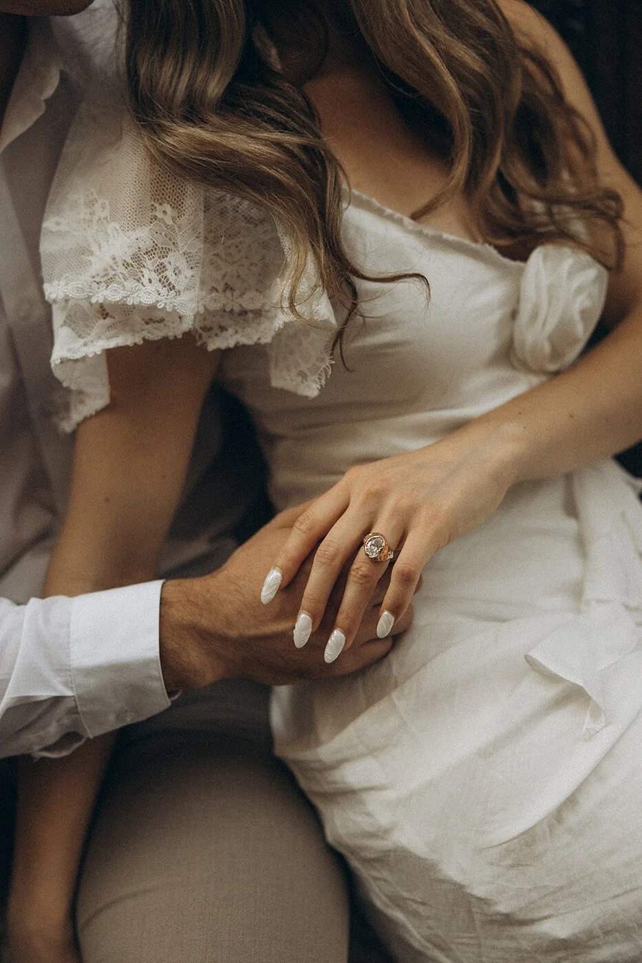 Close-up detail of couple’s hands during their elopement session in Paris, storytelling engagement photography.