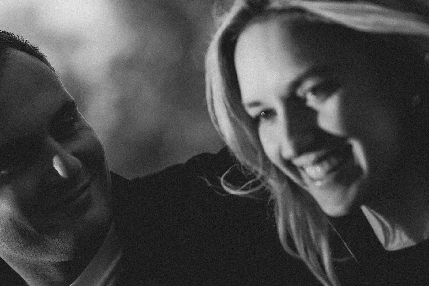 Black and white candid photo of a couple walking through the streets of Paris.