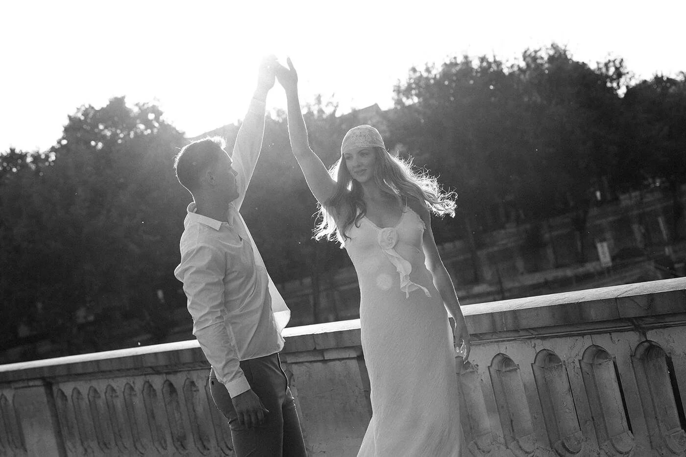 Bride twirling by the Seine River during a Paris destination elopement, cinematic and romantic couple photography.
