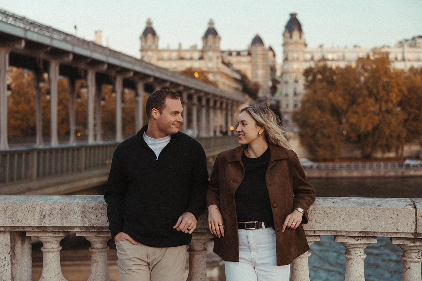 Moody cinematic portrait of a couple in Paris captured in warm evening light.