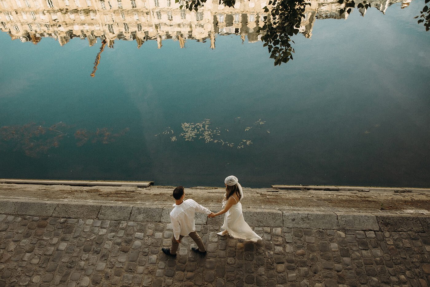Intimate Paris elopement moment by the river, natural and emotional couple photography in a historic Paris setting.