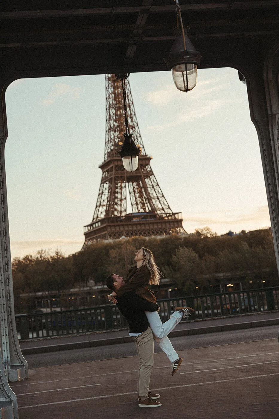 Playful couple moment captured by a Paris couples photographer with Eiffel Tower views.