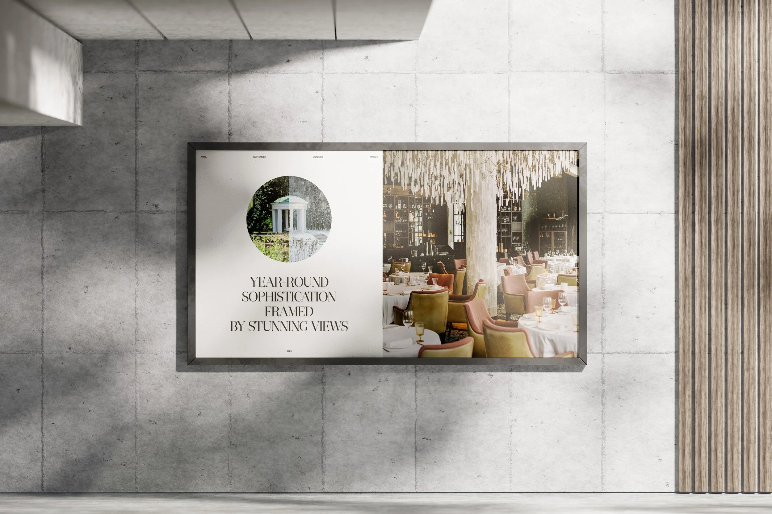 A framed poster on a concrete wall with an interior view of a restaurant, showing tables, chairs, and a chandelier.