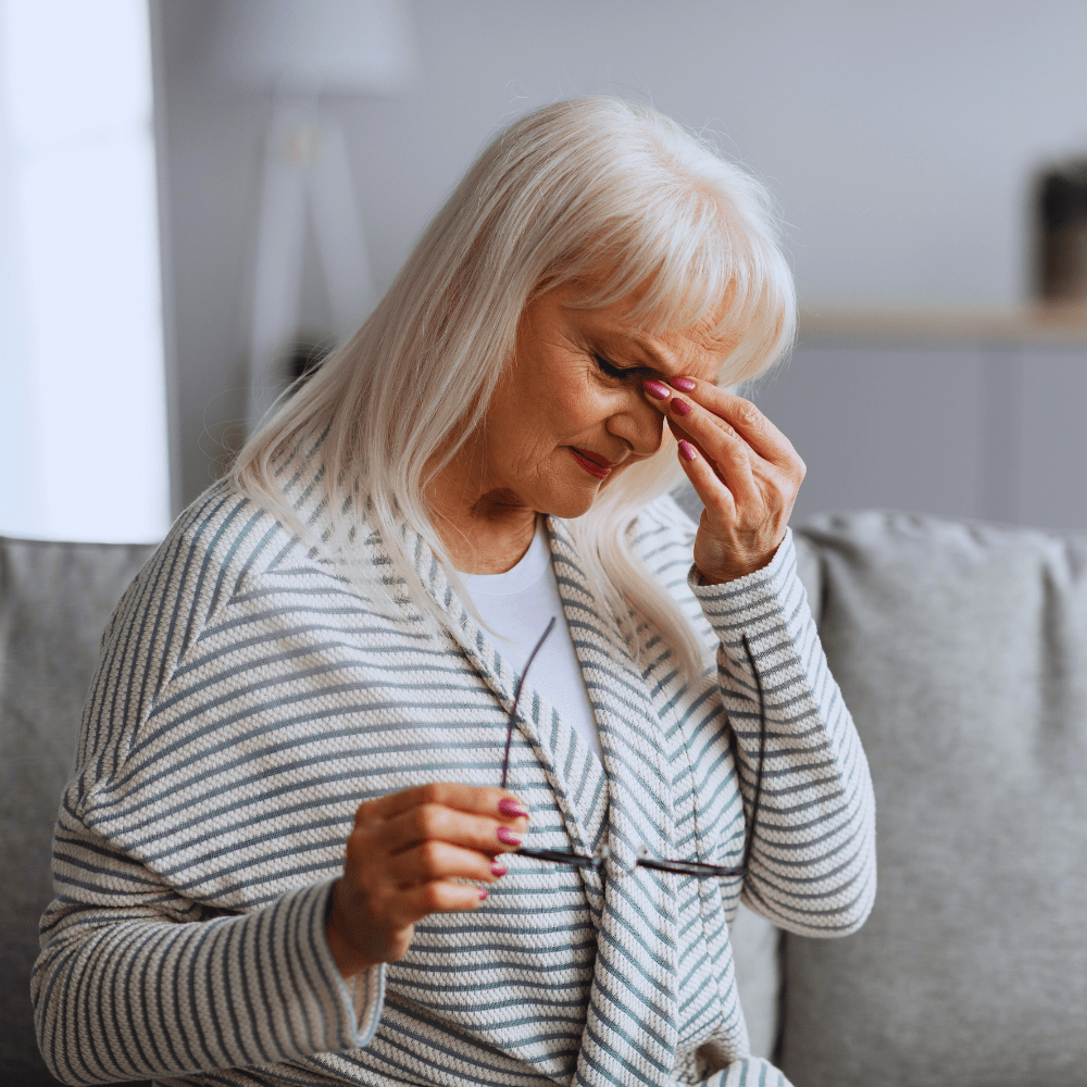 woman pinching in between her eyes
