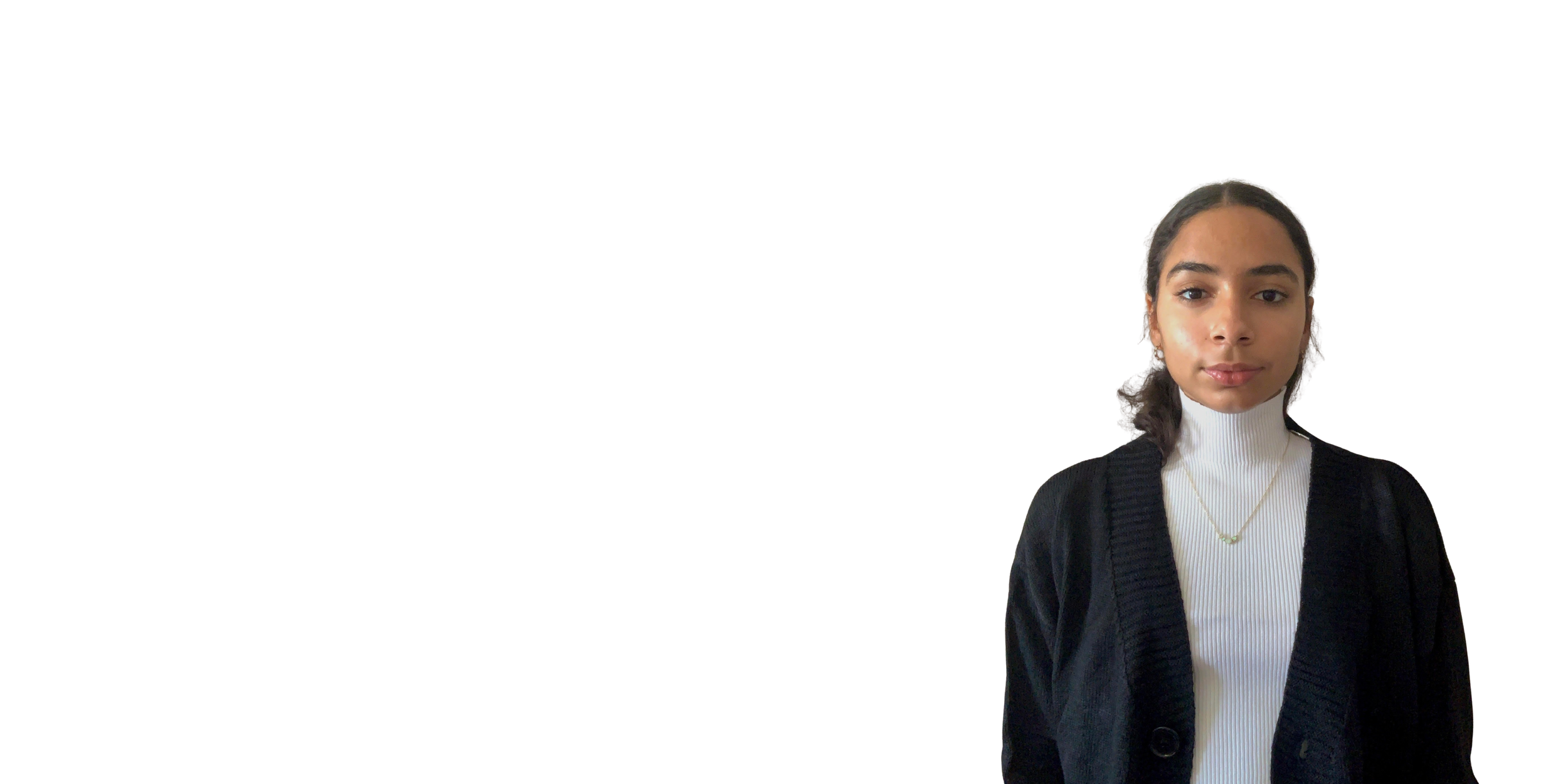 Young woman with dark hair tied back, wearing a white turtleneck sweater, black cardigan, and a necklace, standing against a plain white background.