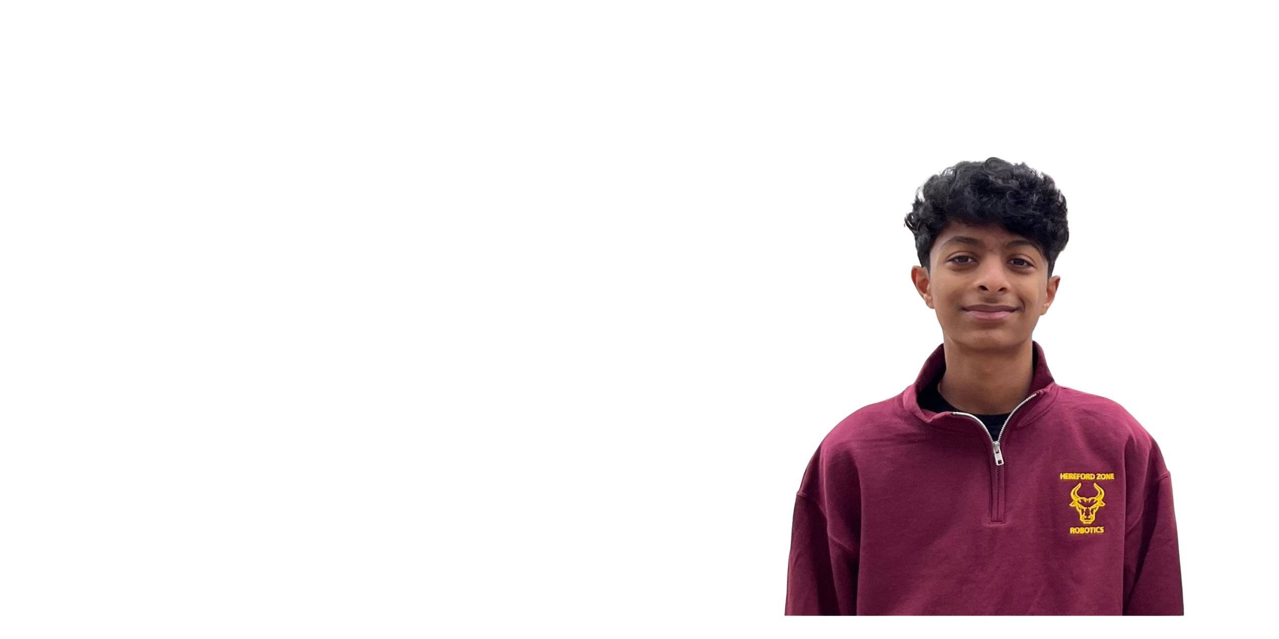 A young man with curly black hair wearing a maroon sweatshirt with a yellow emblem and text that reads 'Hereford Zone Robotics' standing against a plain white background.