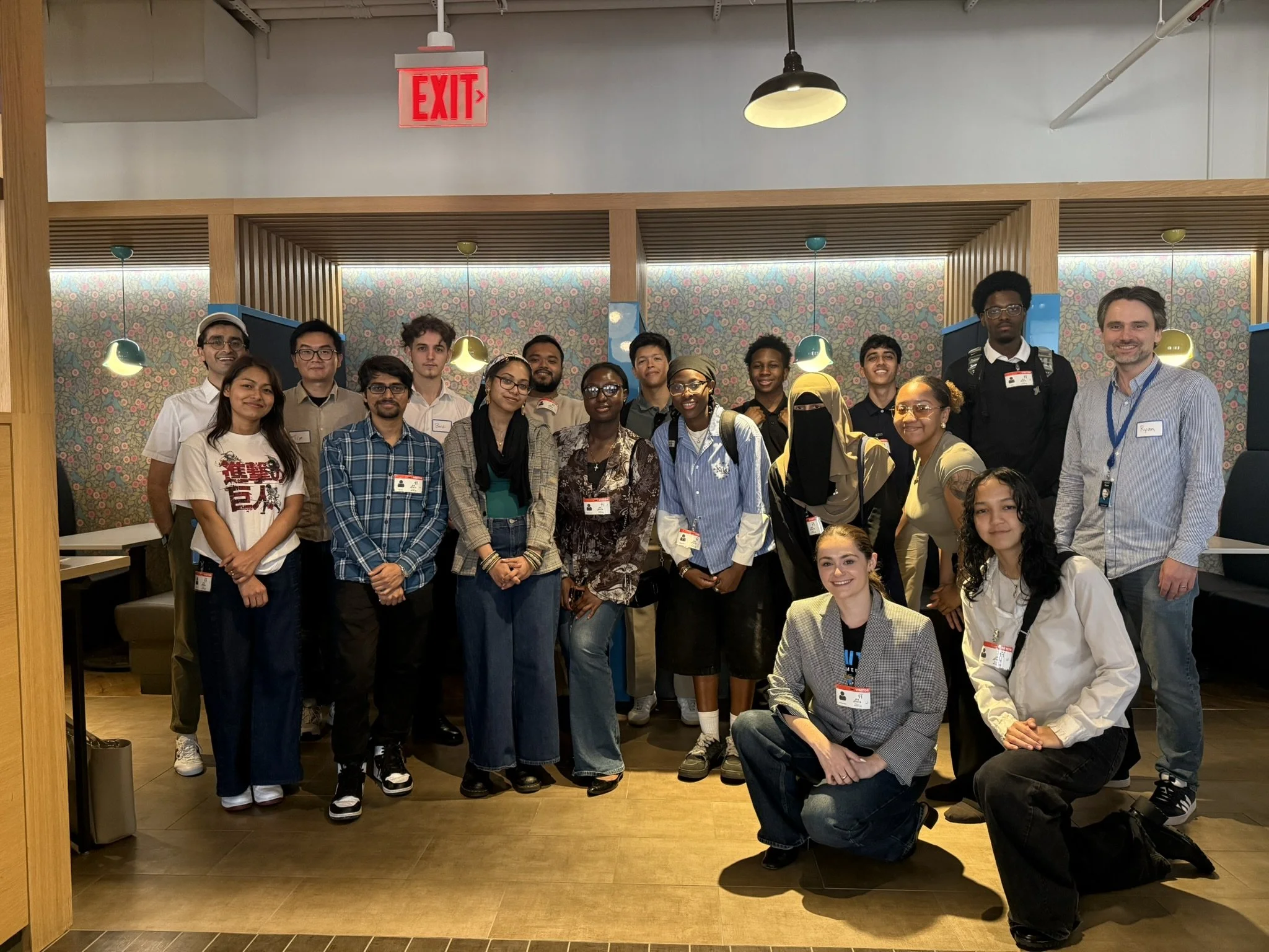 Group of diverse people posing for a photo in a restaurant or cafe.