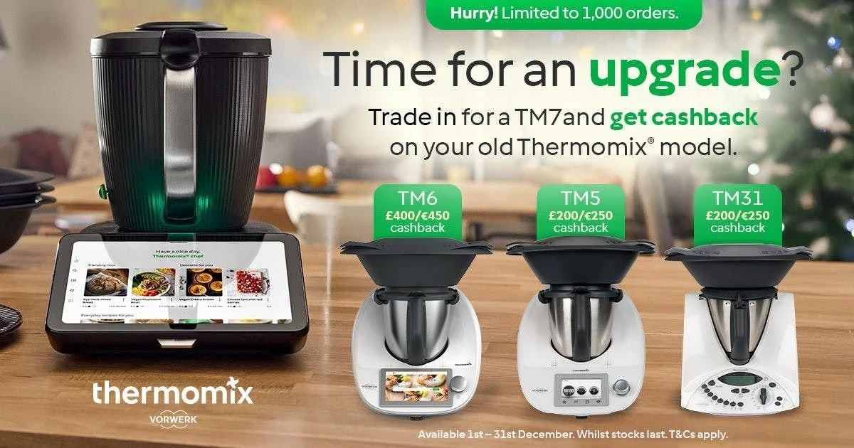 Advertisement for Thermomix upgrade offers showing three models with cashback deals, a large black kitchen appliance, and a tablet displaying recipes on a wooden table.