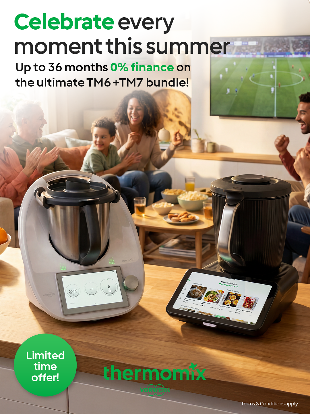 A group of people, including children and adults, sitting together on a sofa in a living room, watching a soccer game on a wall-mounted TV, celebrating and enjoying snacks. On the table in front, there are two Thermomix kitchen appliances, one in white and one in black, with a tablet displaying a recipe.