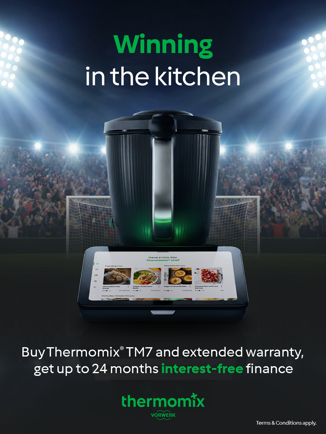A promotional image showing a Thermomix TM7 kitchen appliance with a touchscreen display in front of a soccer stadium filled with cheering crowd, with bright stadium lights overhead. The text reads, 'Winning in the kitchen,' and additional text offers interest-free financing with extended warranty.