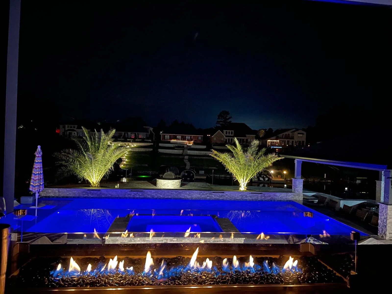 Putting the elements of fire and water together to create a magical setting!  This is the view from the upper covered porch above the pool deck!  It is complete with an outdoor couch and a suspended bed for a quick afternoon nap! 