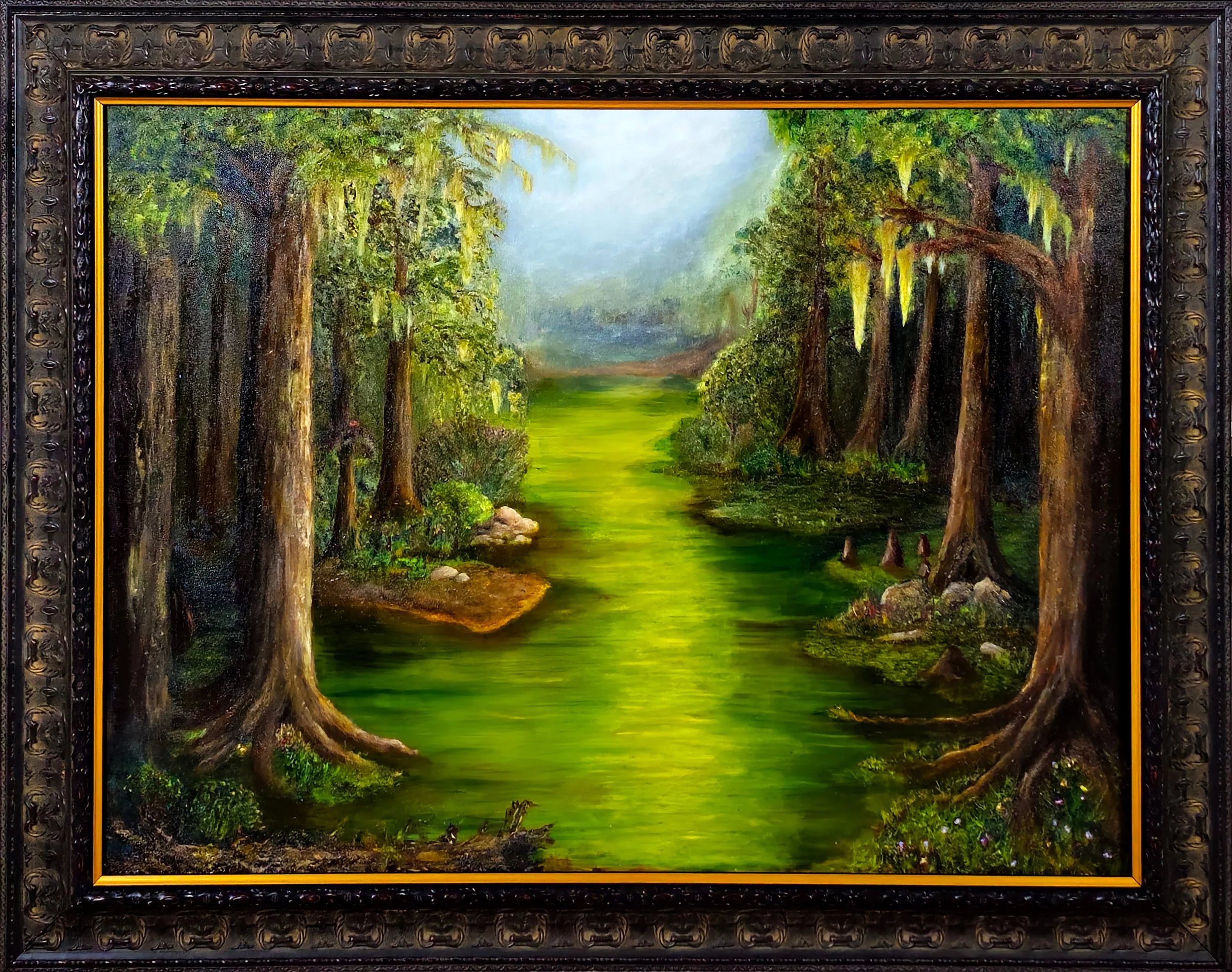 A swamp landscape painting of a lush green swamp with tall trees, Spanish moss hanging from branches, and a quiet waterway flowing through the scene, framed in an ornate dark wood frame.