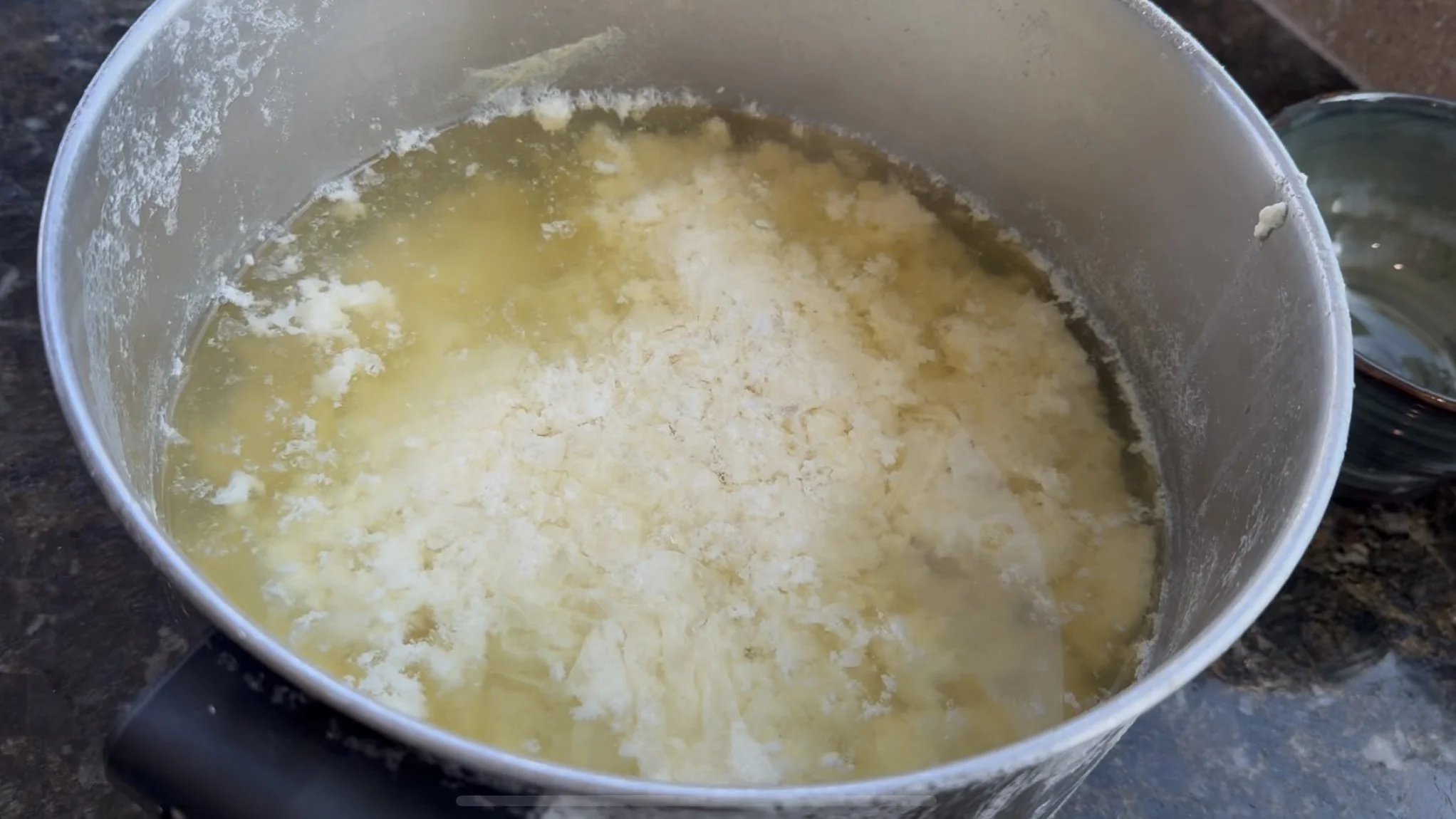 Tofu curds that have coagulated after adding nigari, part of making homemade tofu.