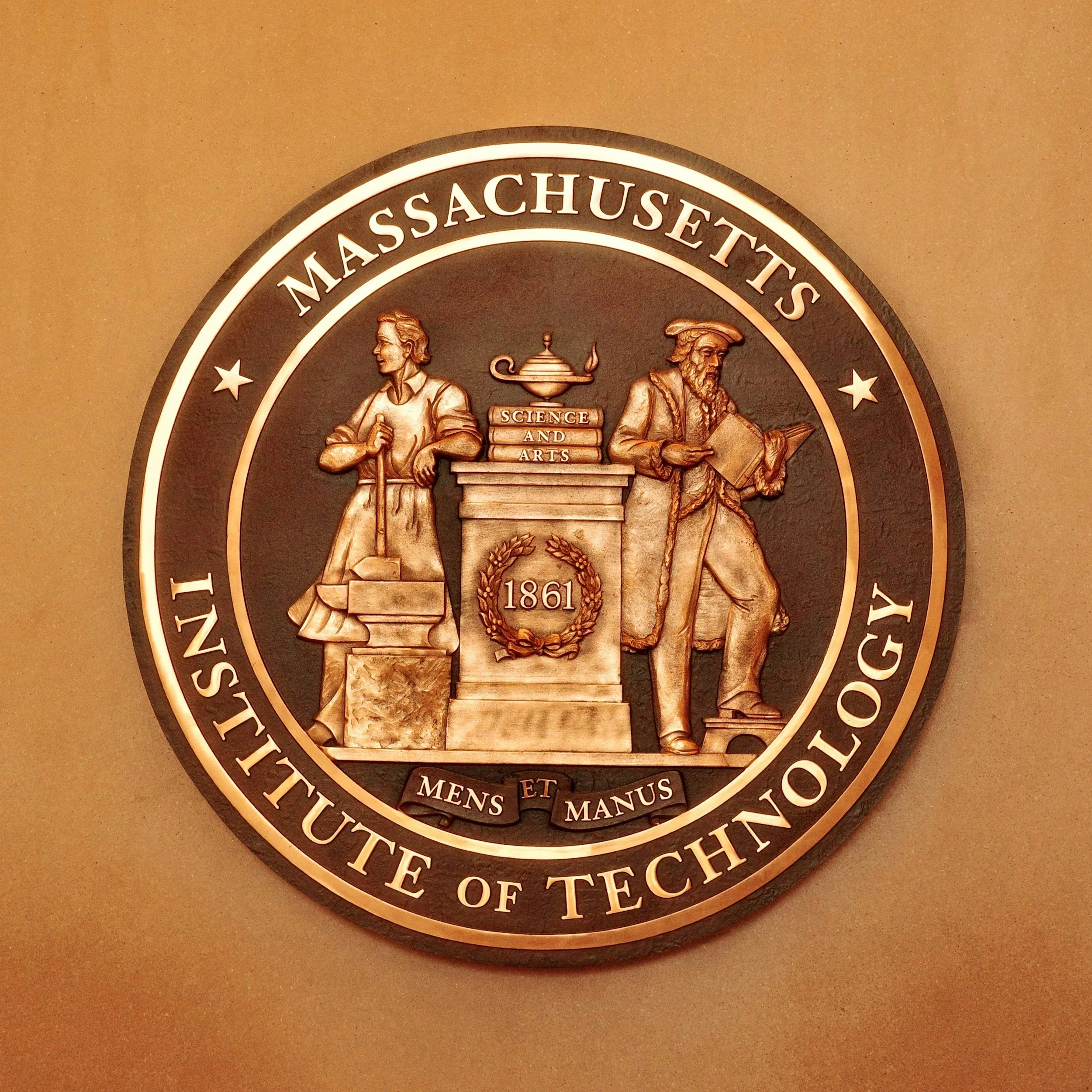 Seal of the Massachusetts Institute of Technology featuring two figures and the year 1861.