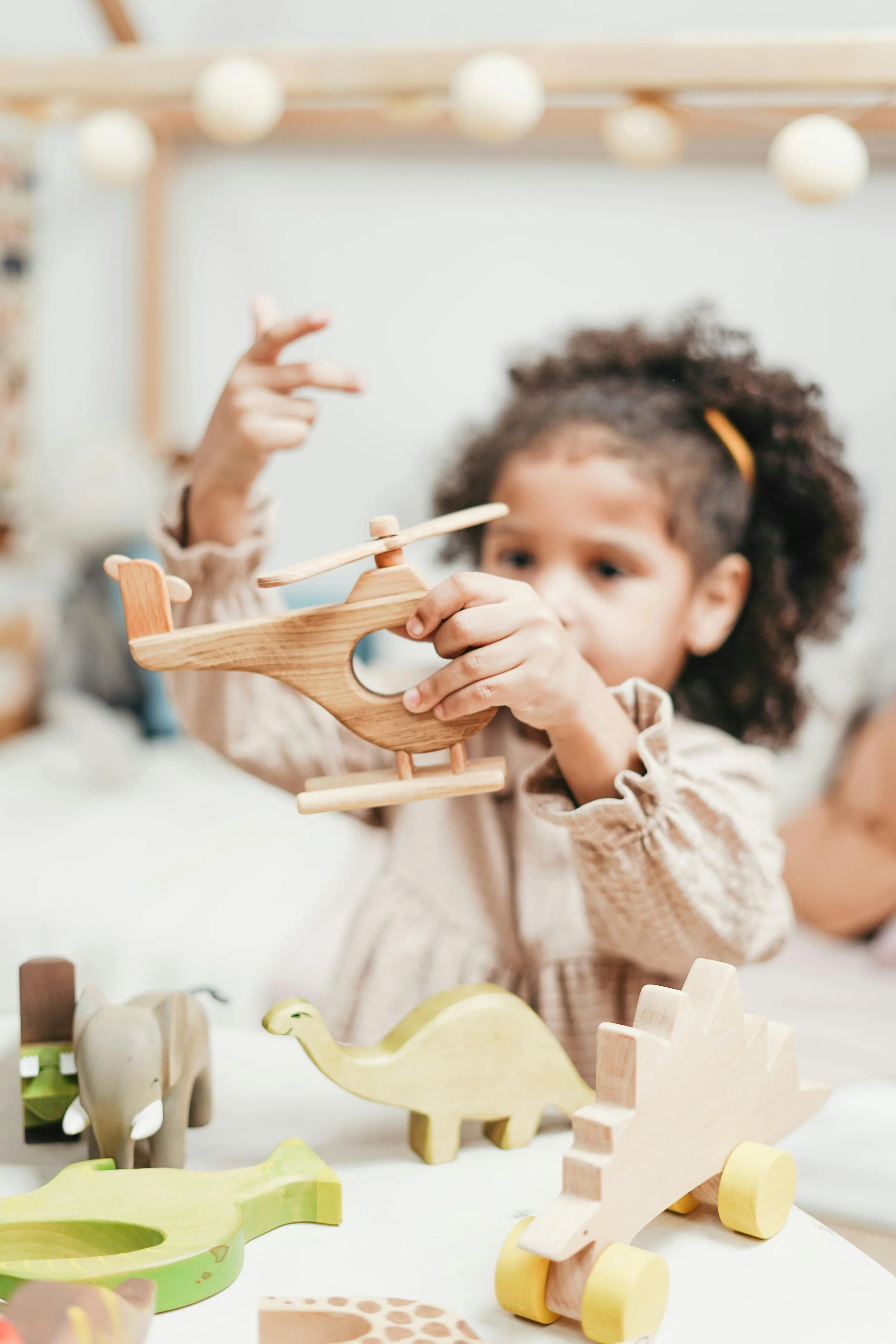 Child playing with educational toys, representing professional nanny jobs and childcare career opportunities available through Little Sprouts & Co. in the San Francisco Bay Area.