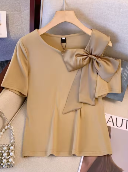 Beige short-sleeve modern t-shirt with a satin bow on the right shoulder