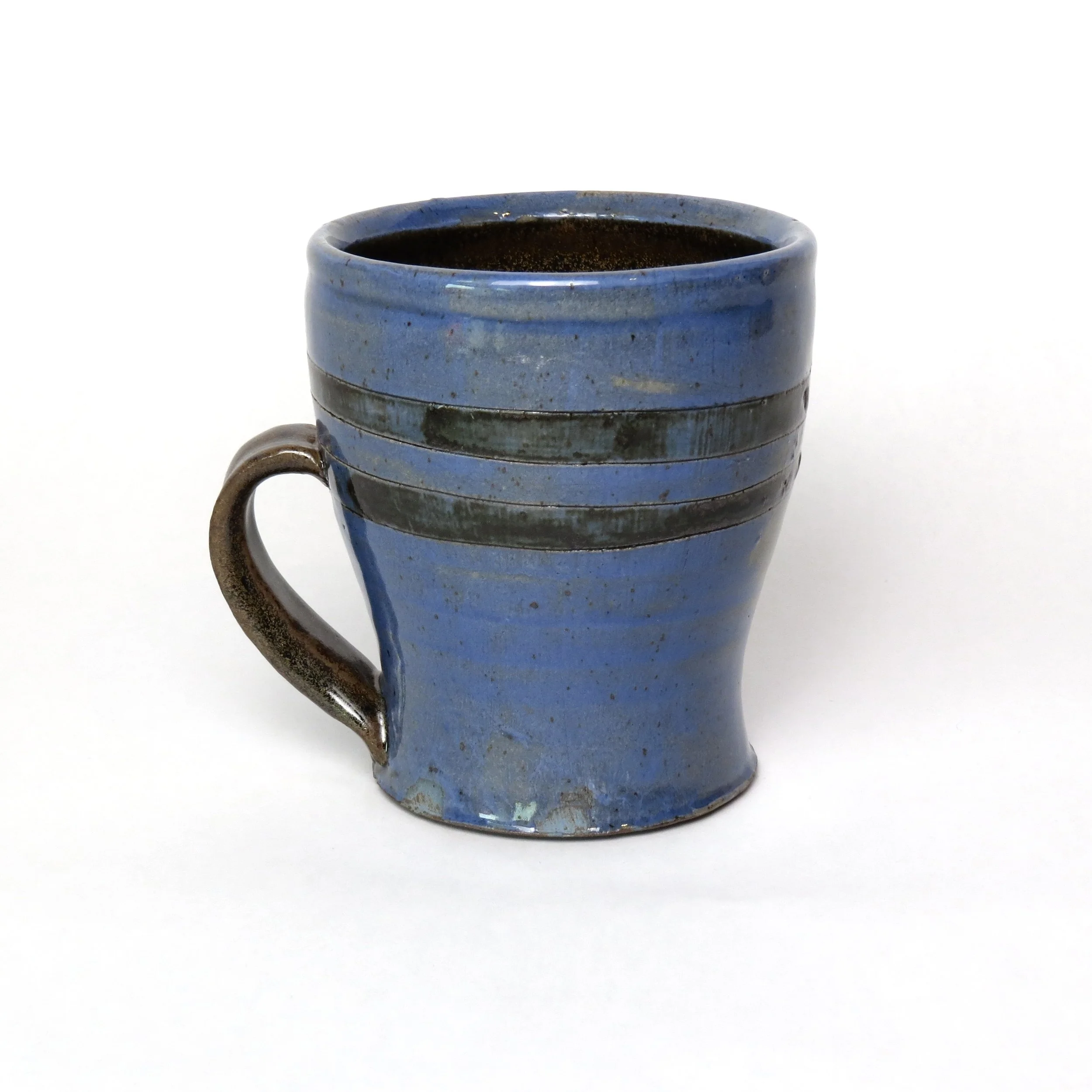 Blue ceramic mug filled with black coffee against a white background.