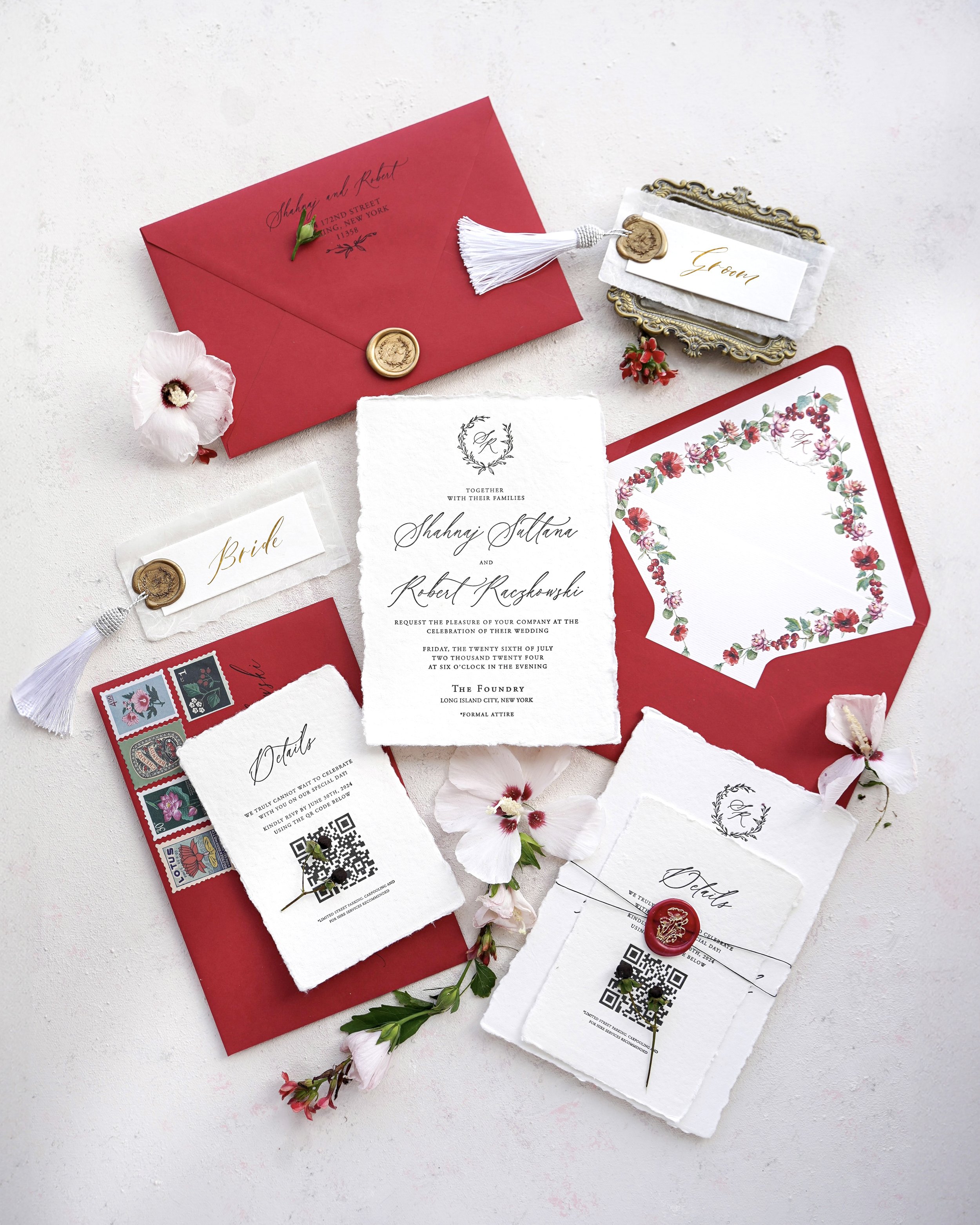 Elegant wedding invitations and details with red, white, and gold accents, including envelopes, RSVP cards, and floral embellishments.