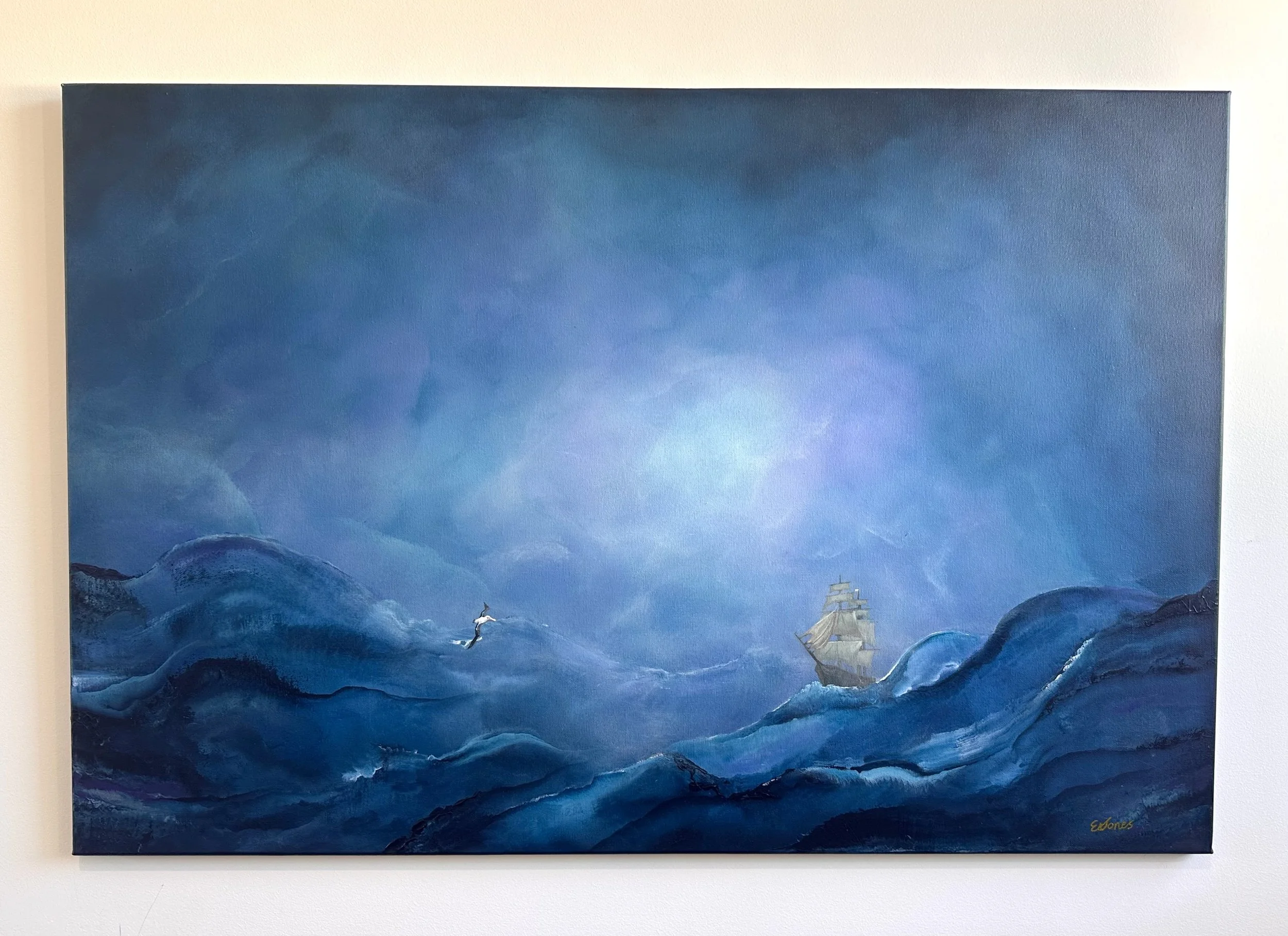 A painting of stormy blue ocean waves with a small sailing ship in the distance and a seagull flying near the water.