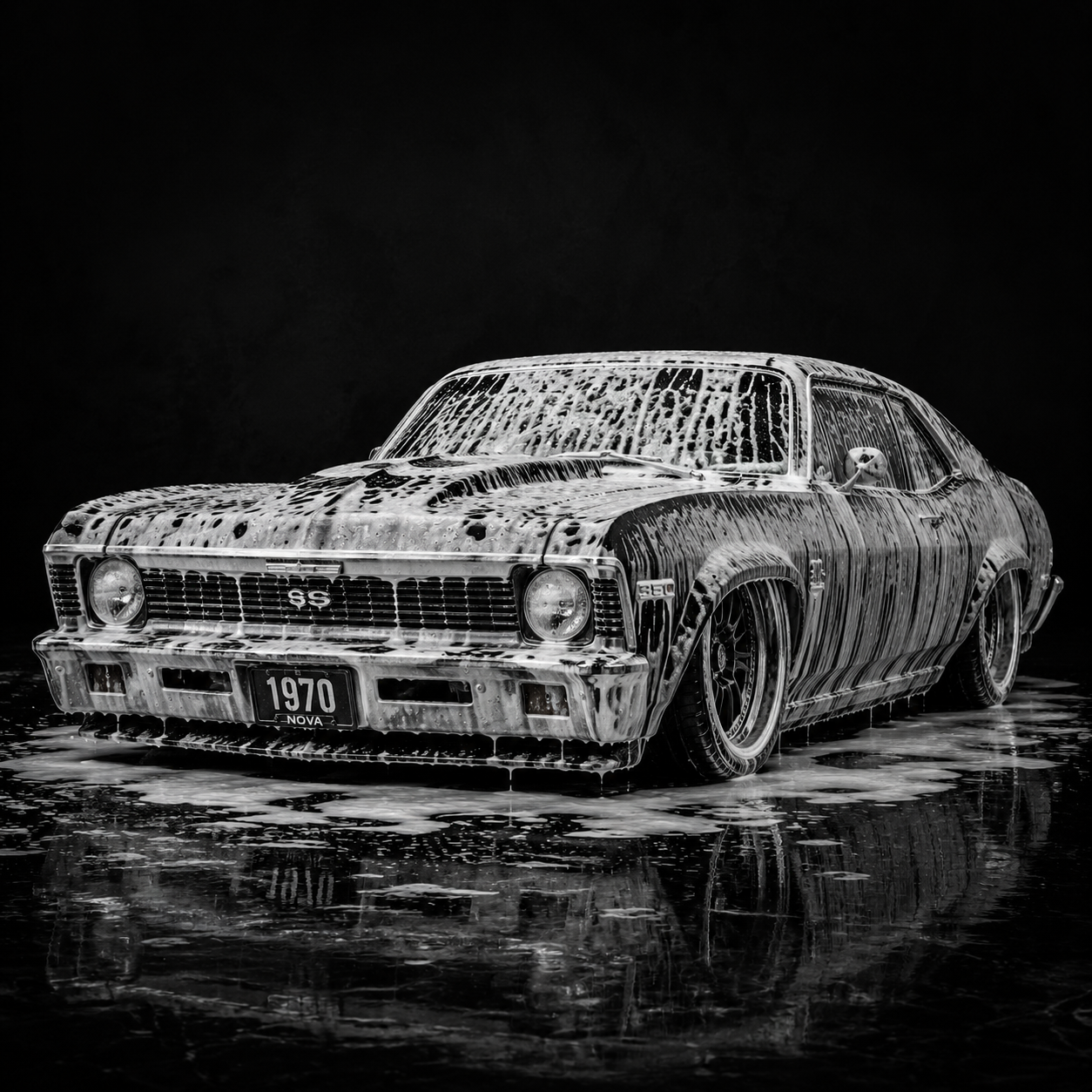 Black and white photograph of a vintage 1970 Chevrolet SS car covered in soap suds, sitting on a wet surface, likely during a car wash.
