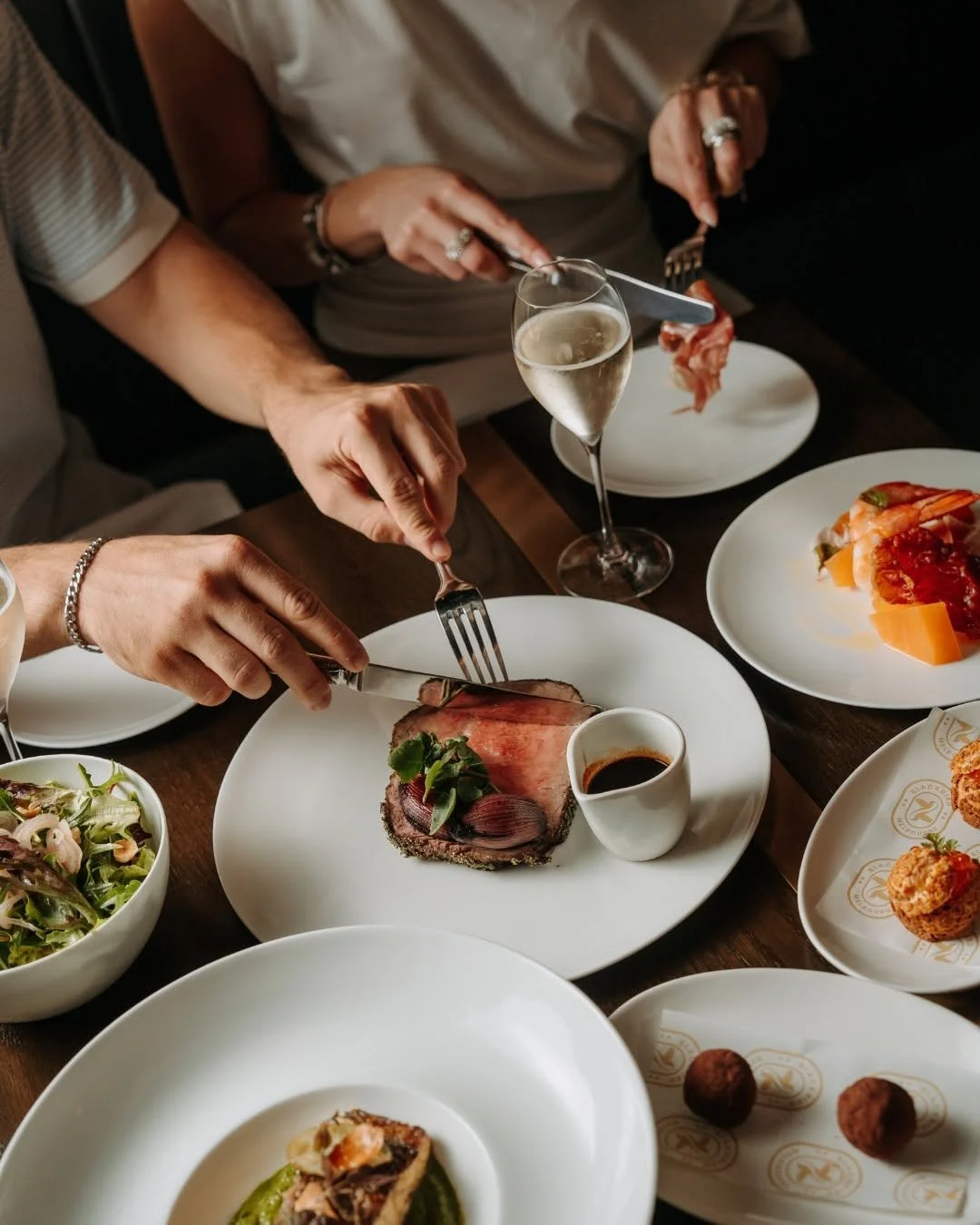 Guests sharing a dish at a Blackbird Melbourne Christmas dinner