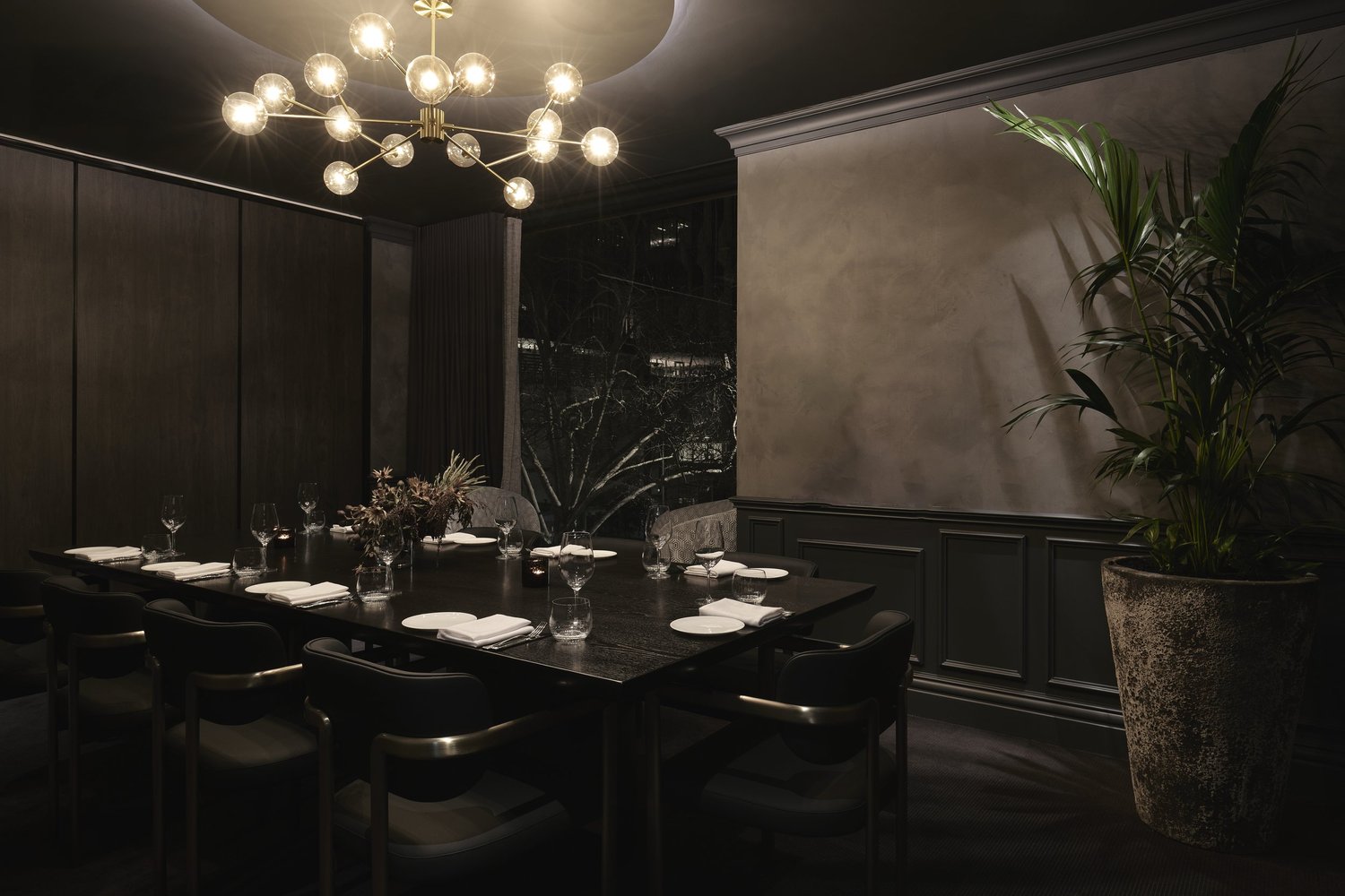 Private Dining Room 2 set for an intimate dinner beside a potted palm