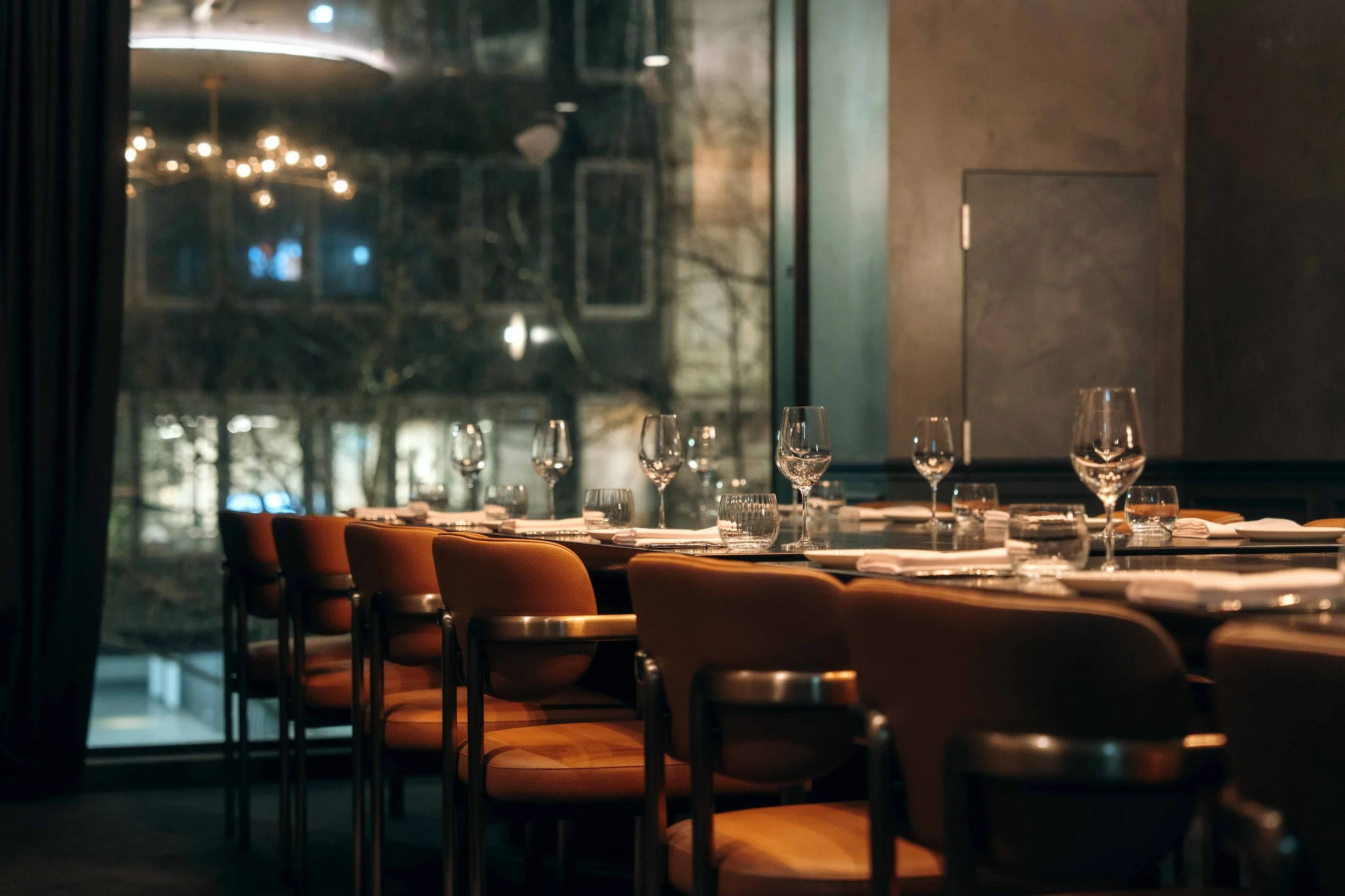 Private dining room at Blackbird Melbourne set for a long table dinner beside floor-to-ceiling windows