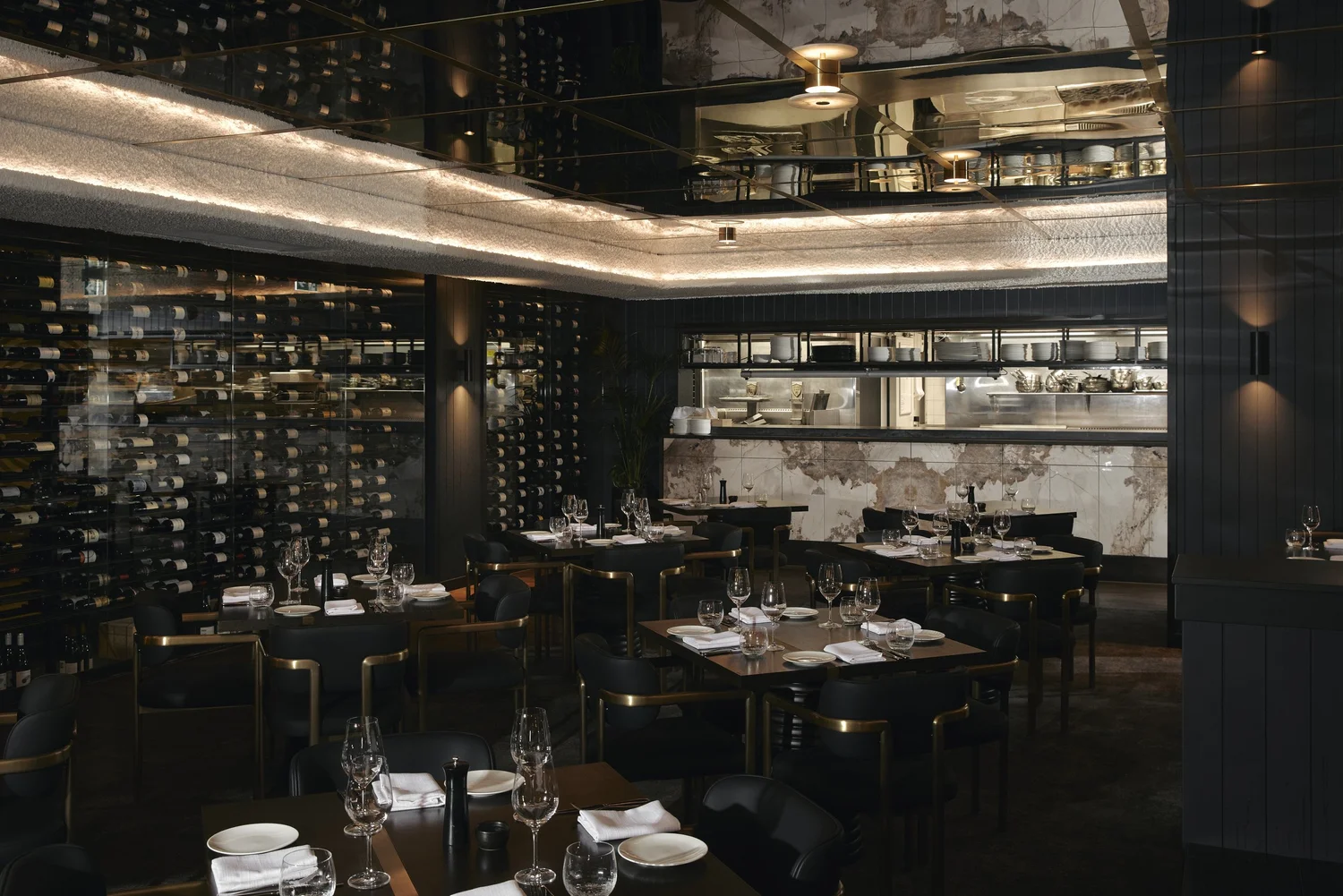 The main dining room with its wine wall and open kitchen