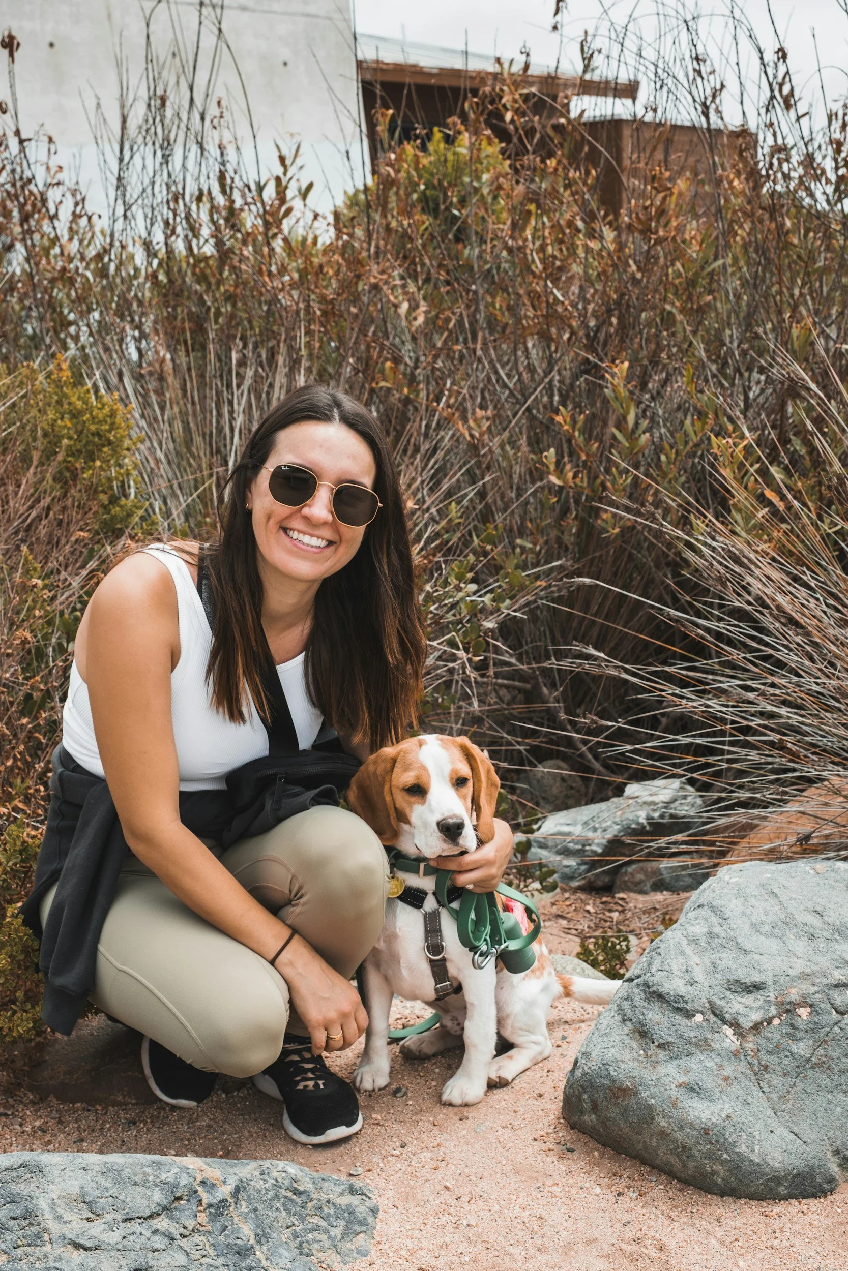 Woman and dog sitting in dessert