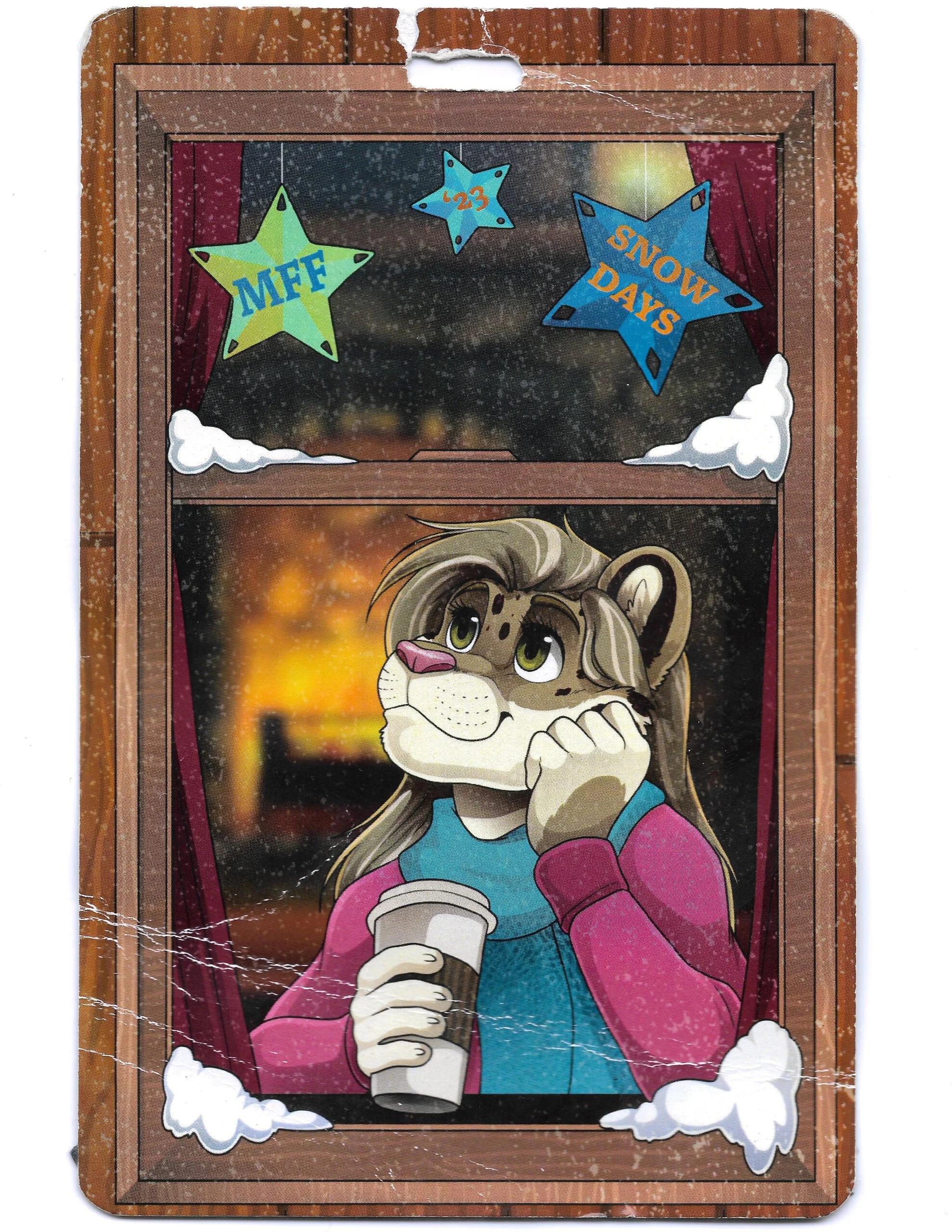 A cartoon lion character holding a coffee cup, looking out a window with snow falling. Decorations include stars with the text 'MFF', '23', and 'SNOW DAYS'.