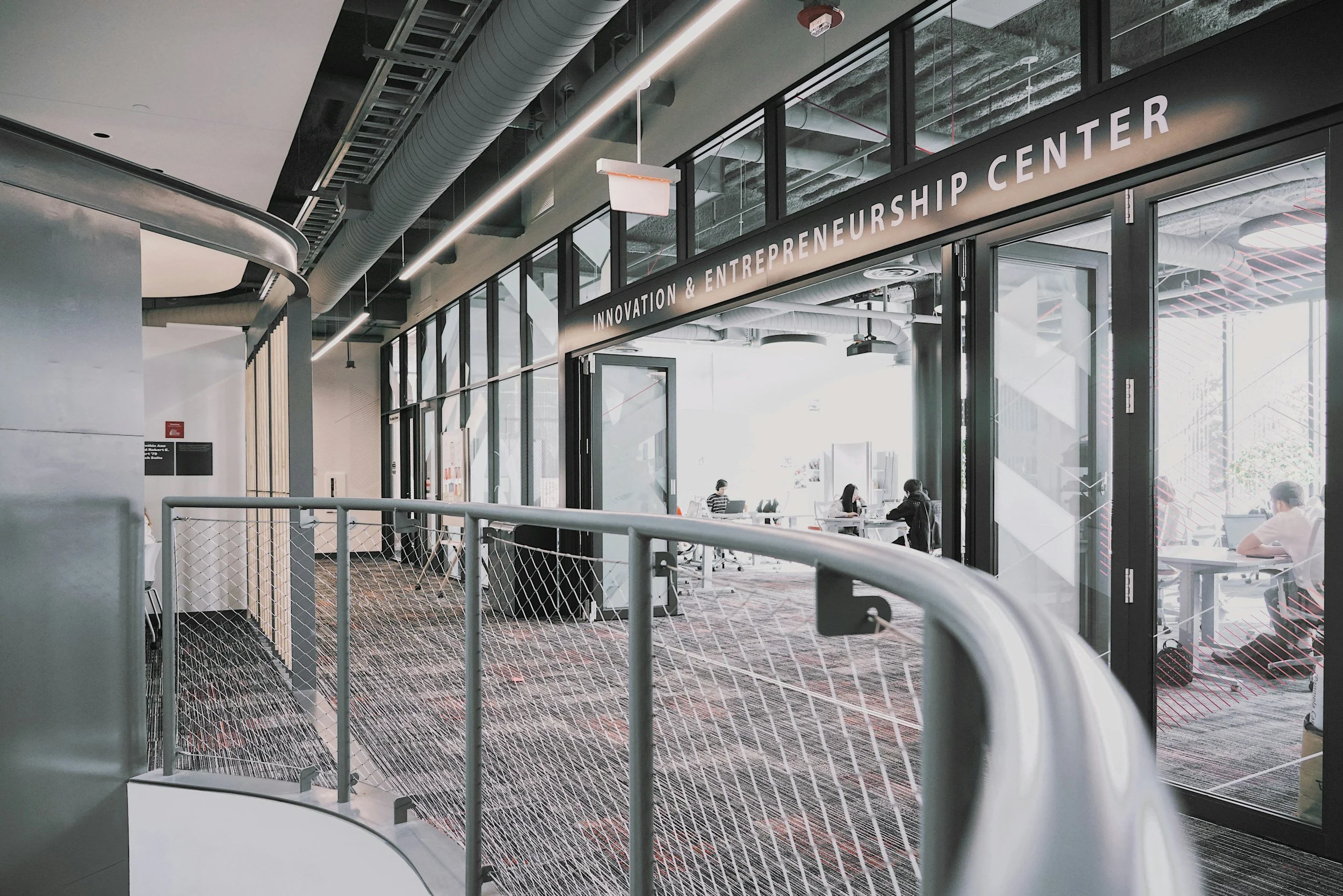 Entrance to Innovation & Entrepreneurship Center with glass doors and people working inside
