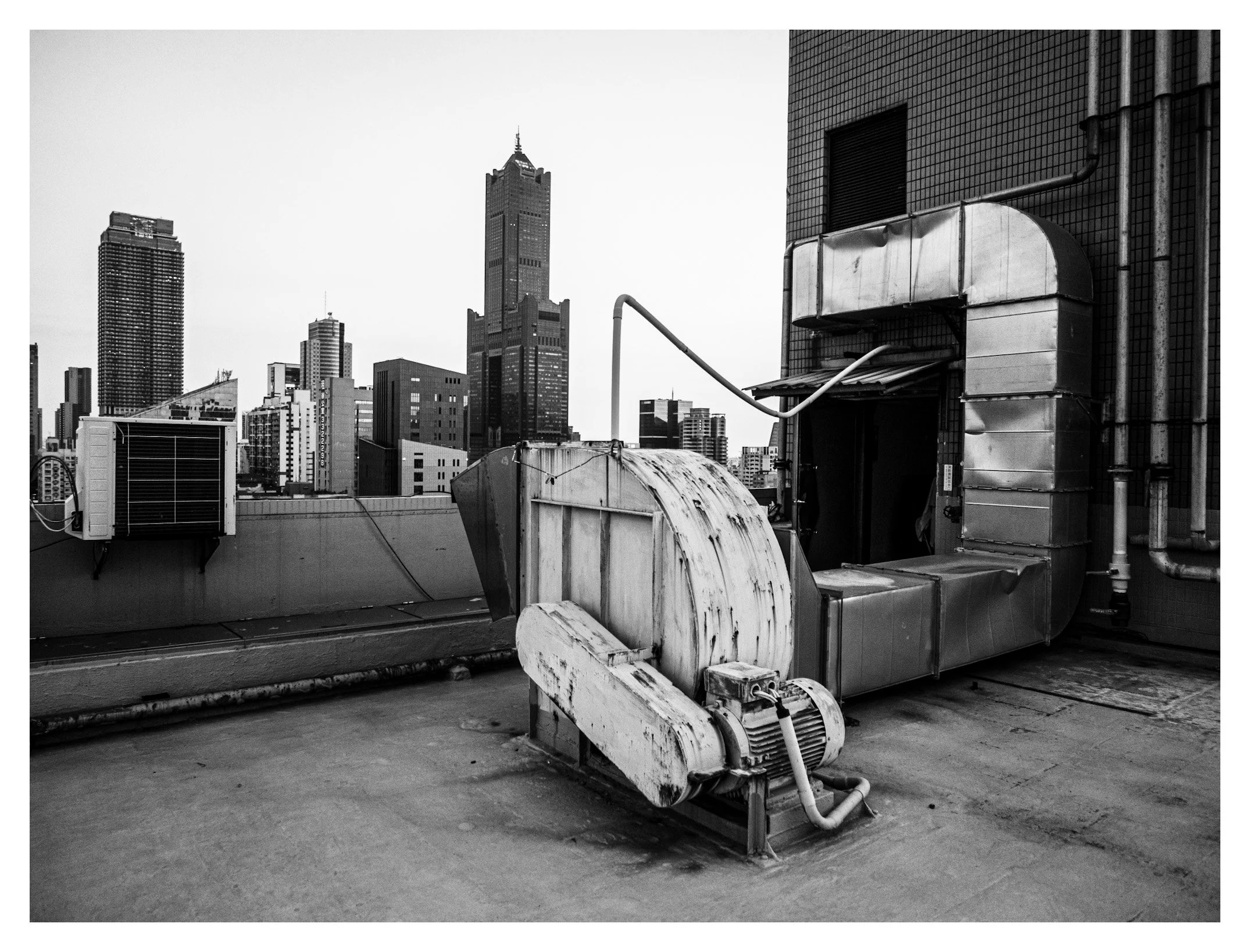 Day 362/365 The Building's Lungs: A Rooftop Blower and the Kaohsiung Skyline