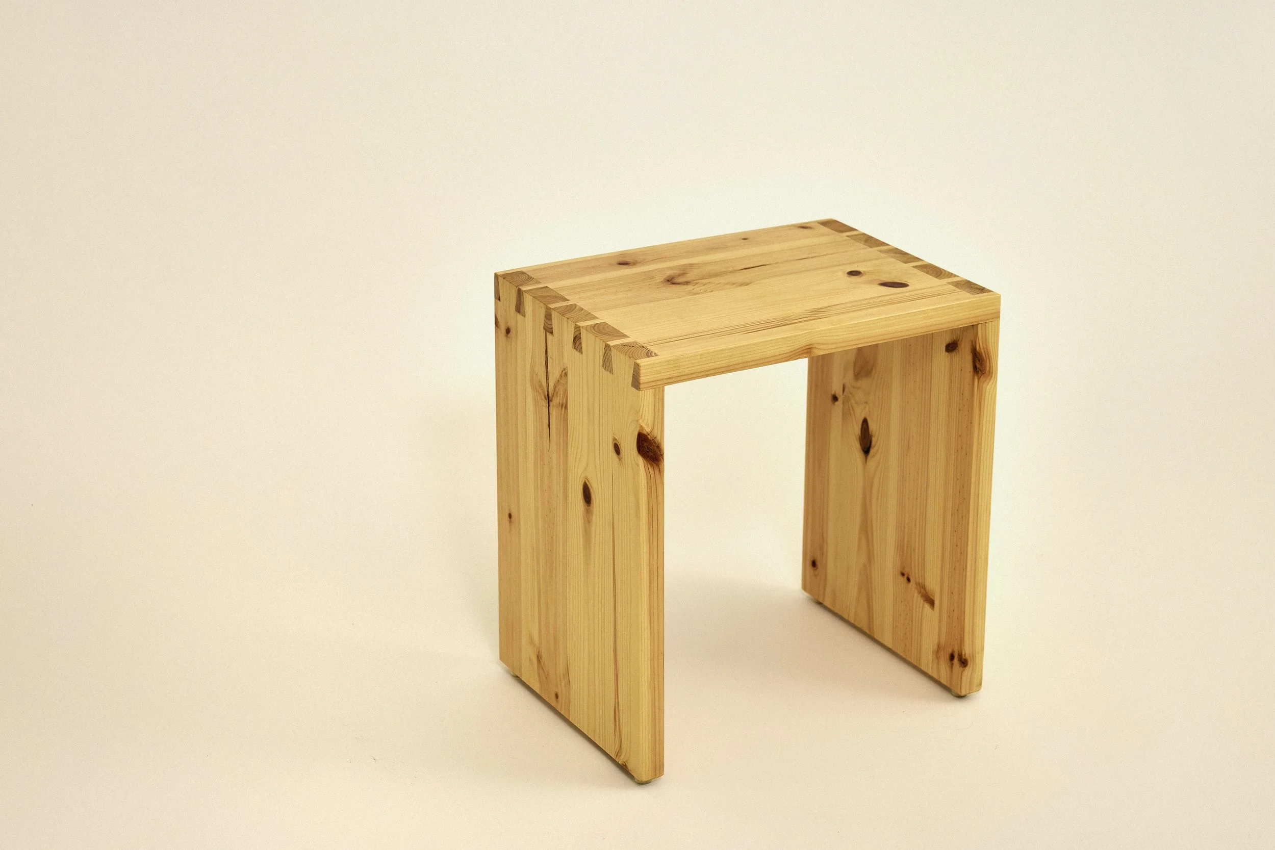 A wooden simple stool made with solid pine featuring dovetail joints. Japanese style.