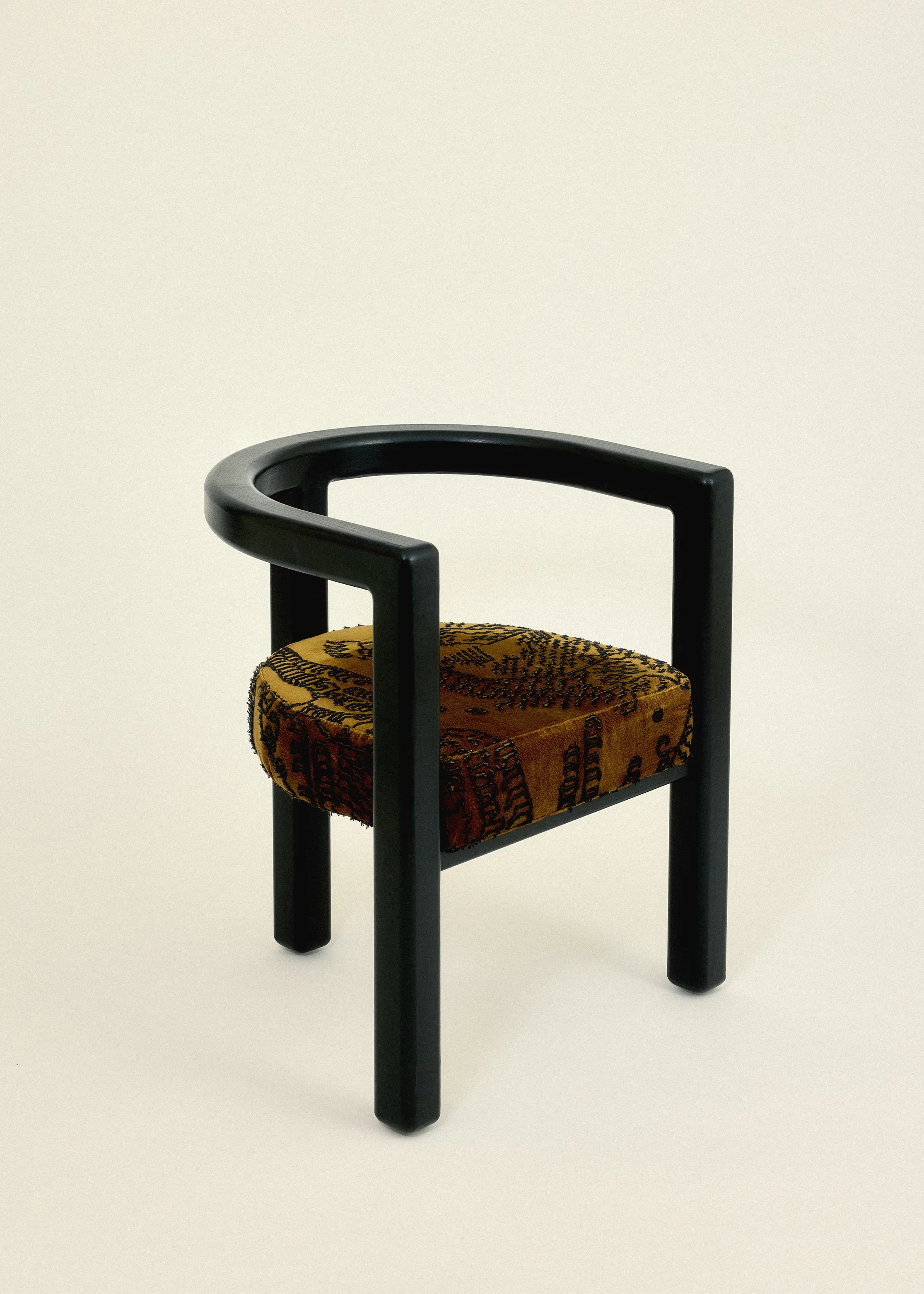 Solid ash chair in black linseed oil paint. Round, tree legged chair with Cedar Tiger mountain upholstery on seat.