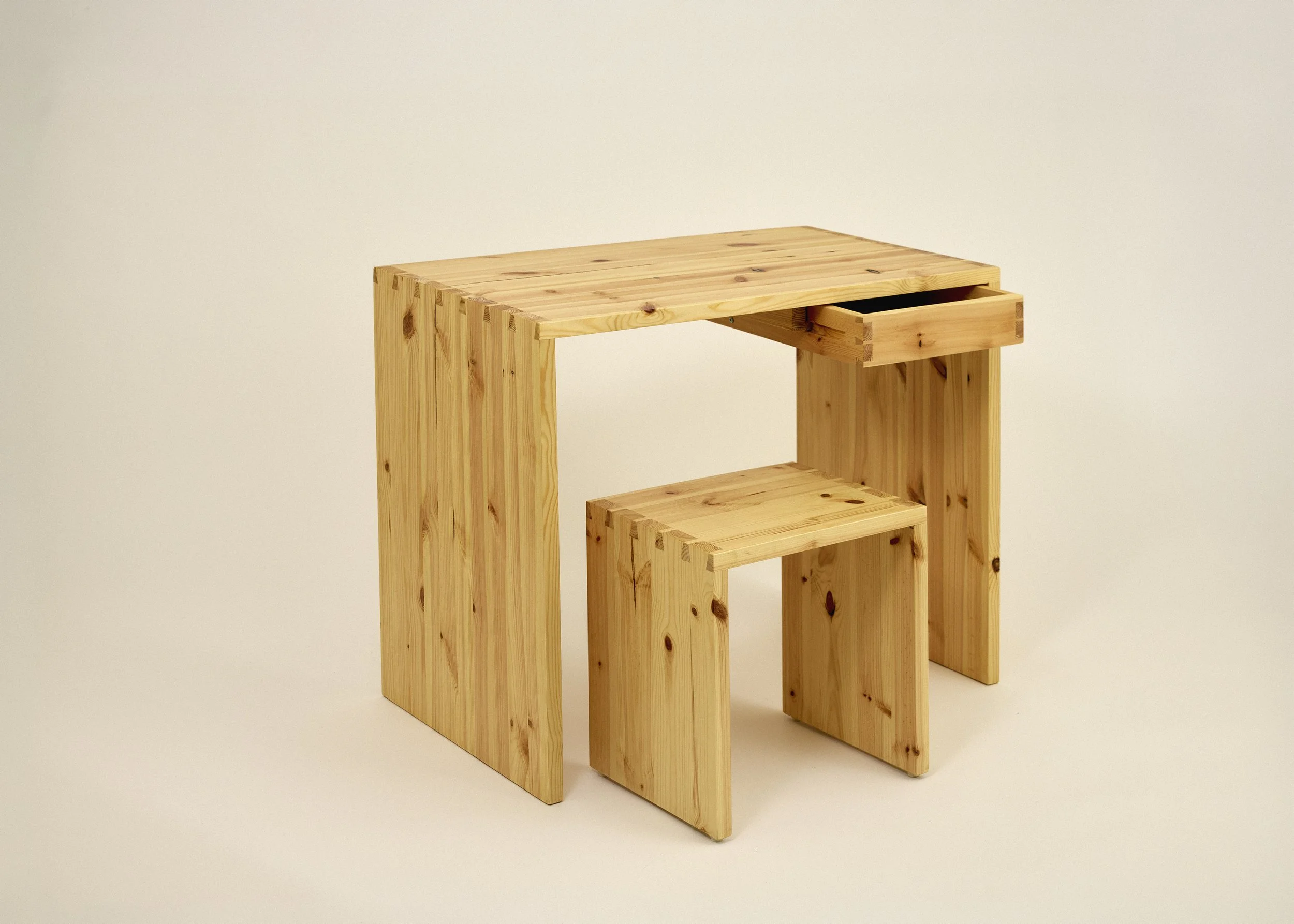 A wooden desk with a small drawer on the right side and a matching stool, made with solid pine featuring dovetail joints. Japanese style.