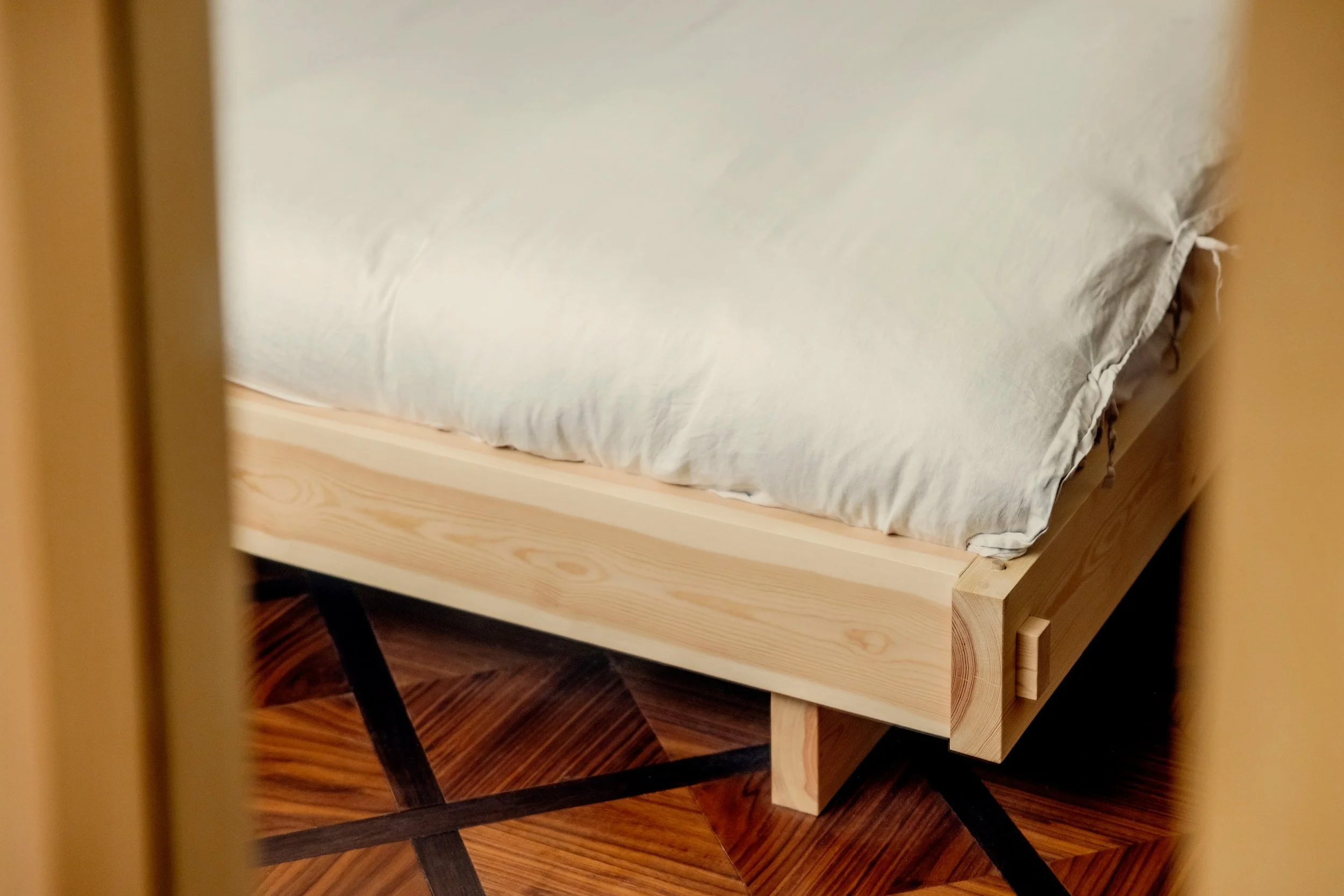 Japanese pine bed on old style walnut flooring. 